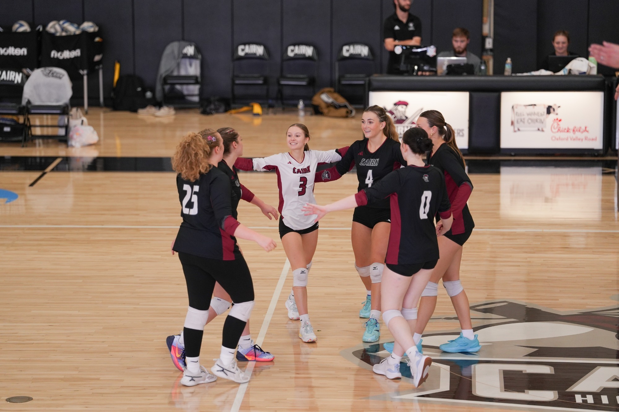 Highlander Volleyball players form a huddle after a point