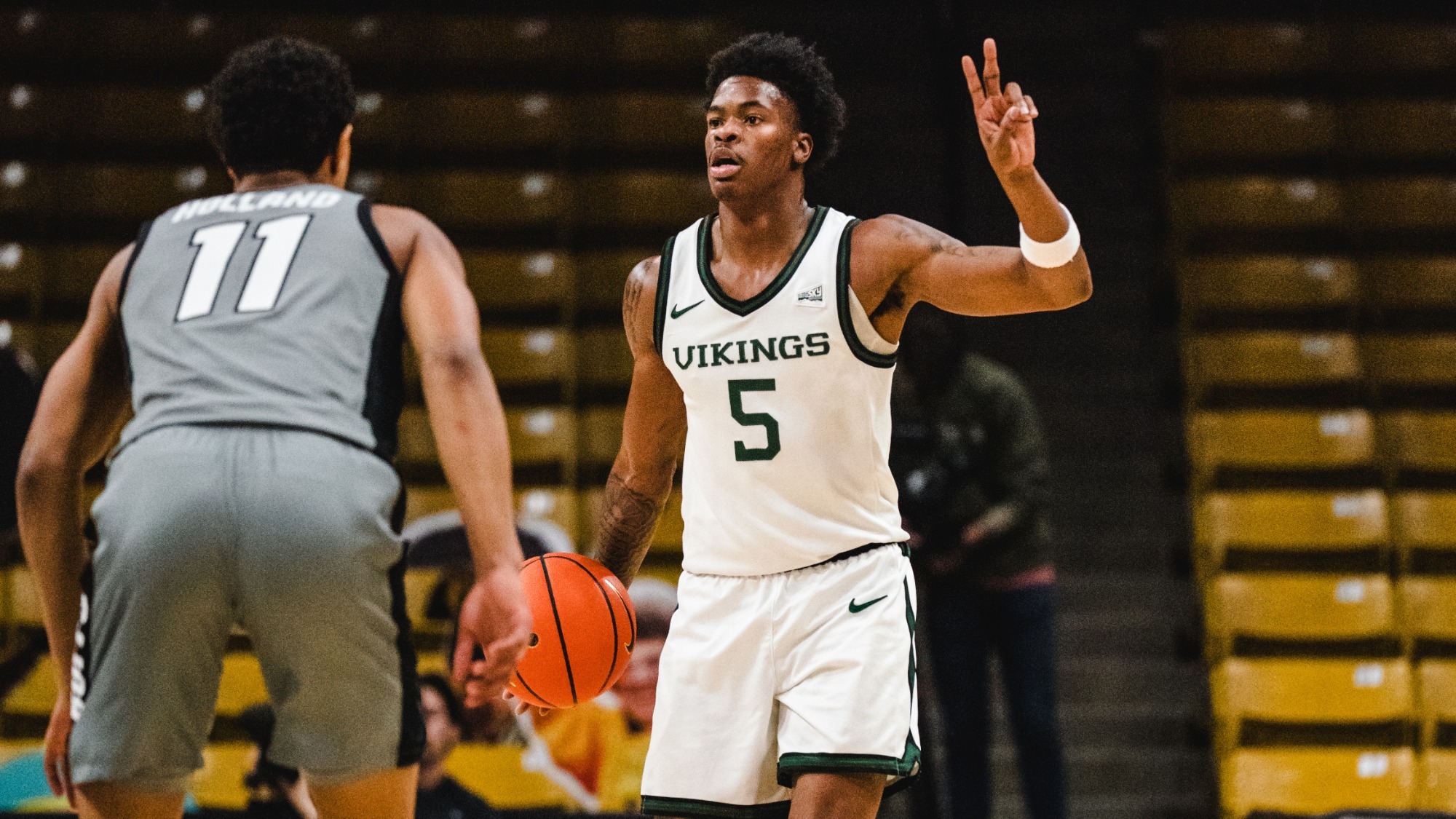 Jaylin Henderson brings the ball up court and calls a play against Colorado.