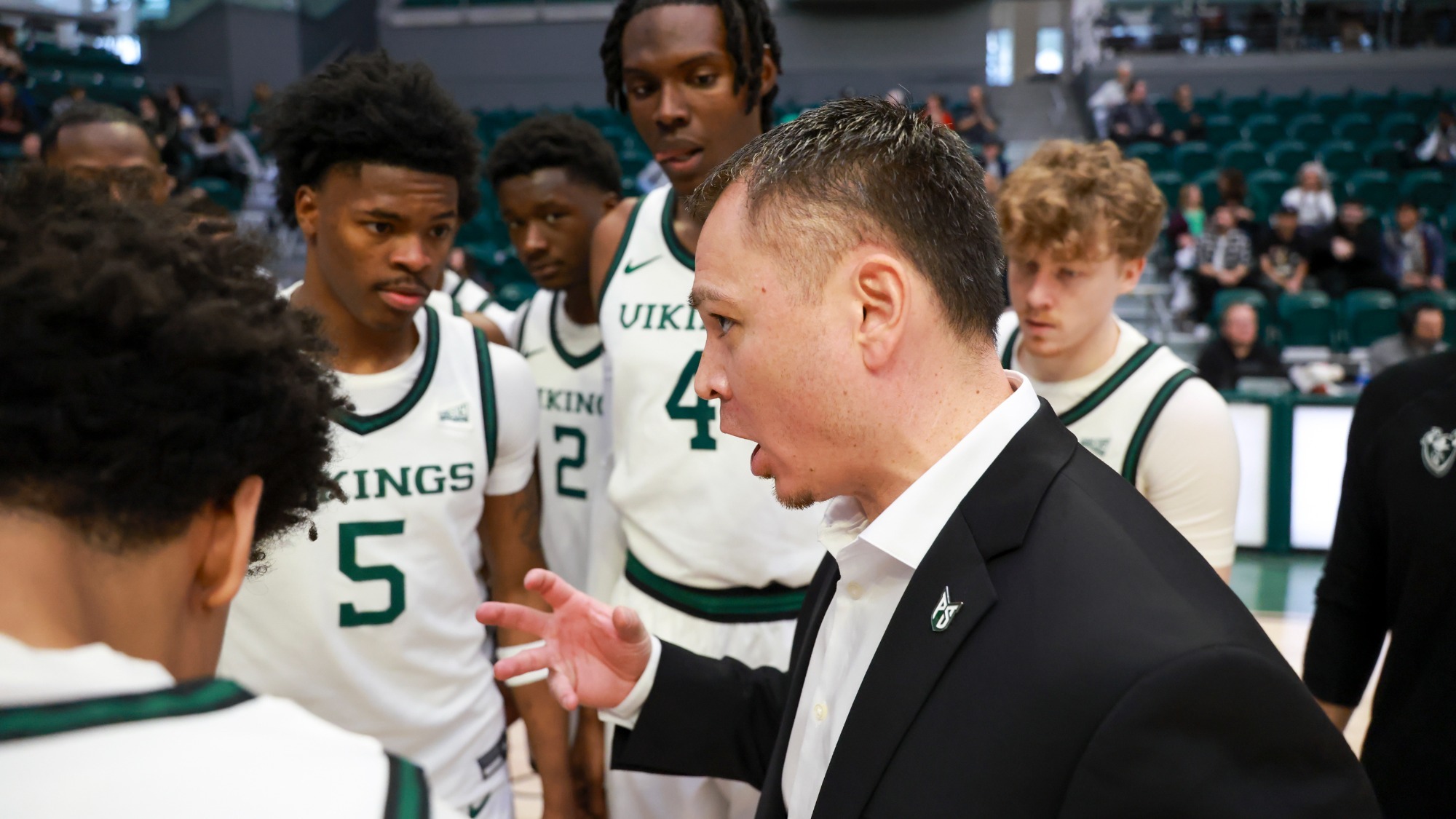 Head Coach Jase Coburn talks to his team at Viking Pavilion