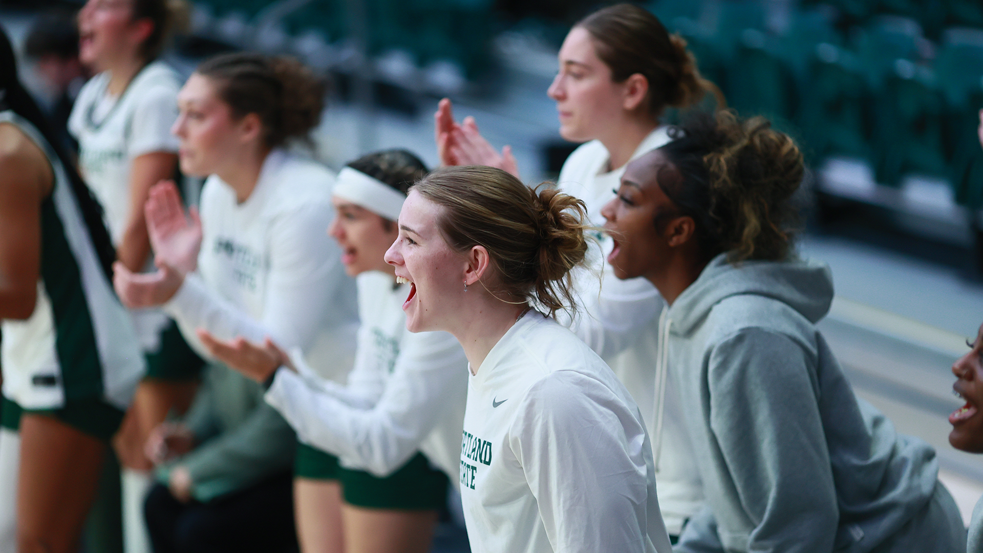 The Portland State women's basketball team's bench celebrates a play during the Vikings' home game against South Dakota.