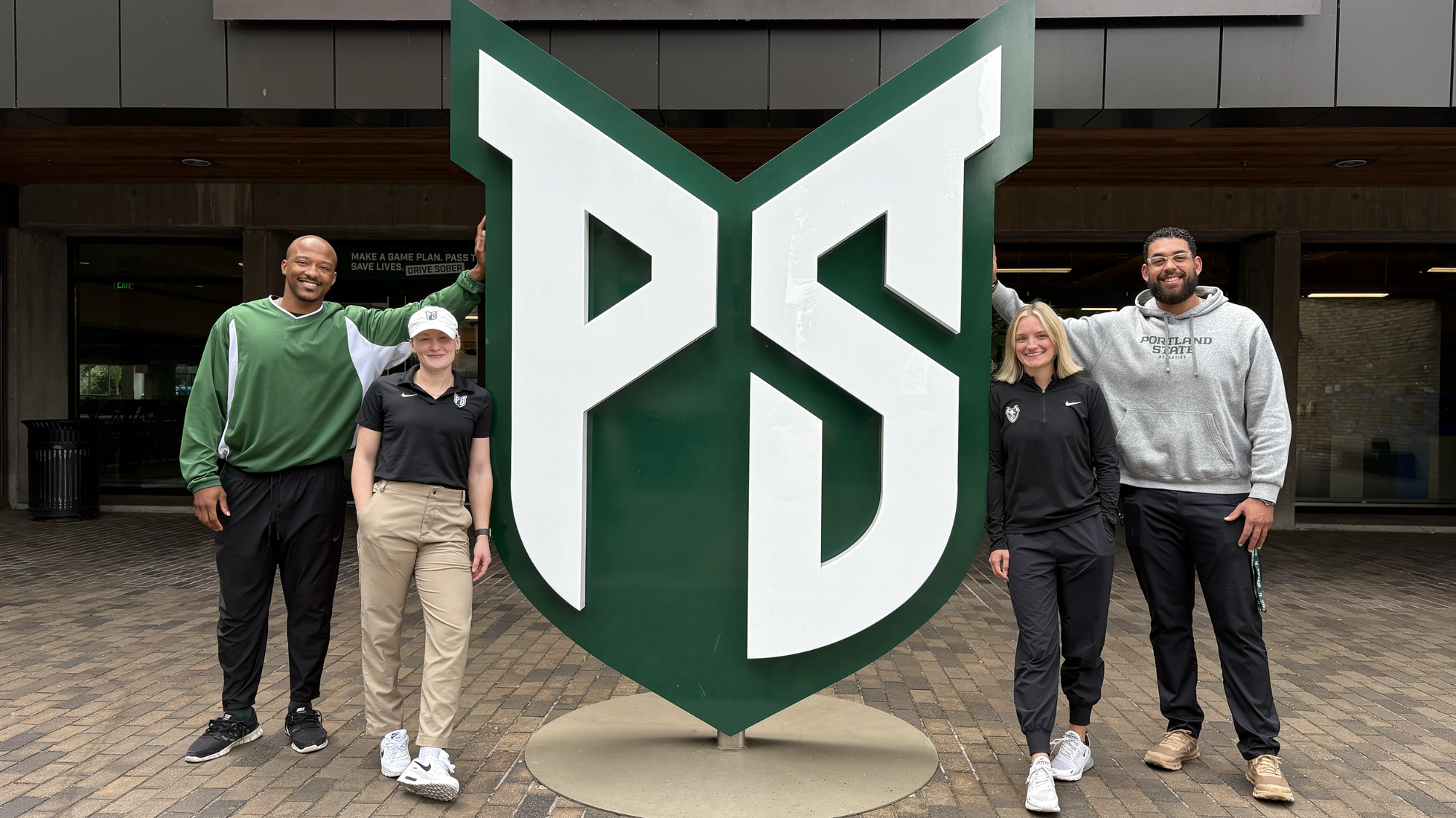 Malik Thirdgill, Olivia Dean, Paige Donathan and Tyson Pauling at the Viking logo totem