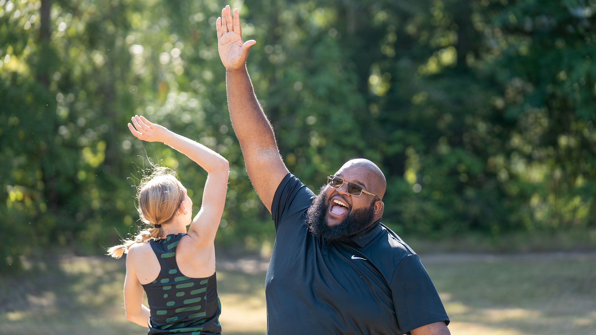 Portland State head cross country and track & field coach Joseph Blue high-fives Emma Stolte after the Lewis & Clark Opener.