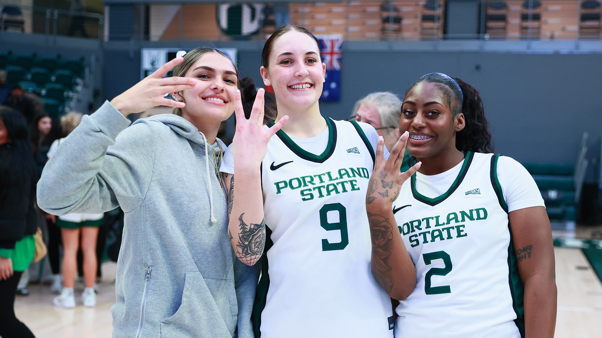 Portland State women's basketball players Alani Encinas, Hannah Chicken and Jamia Carter hold up 