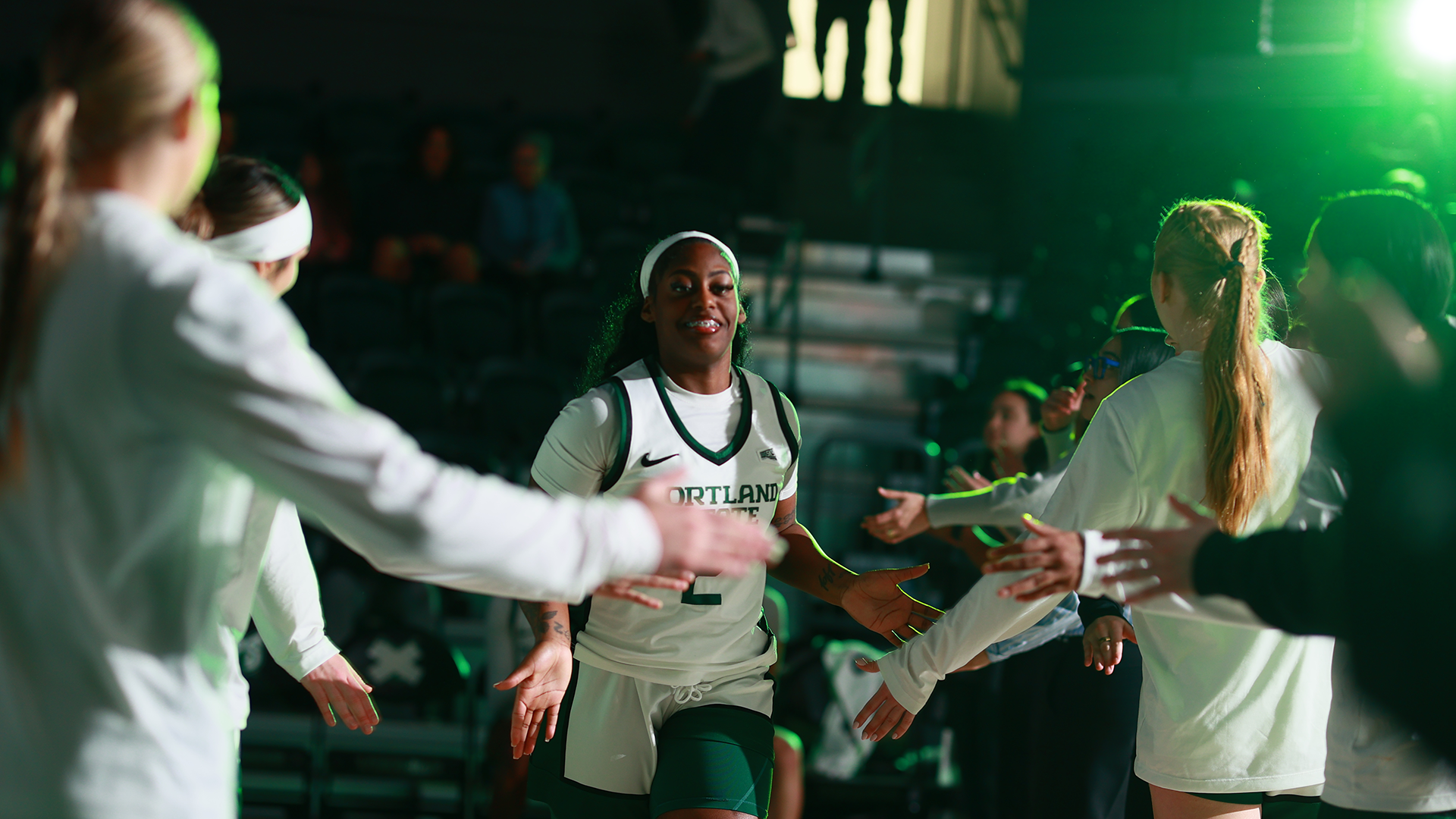 Portland State women's basketball player Jamia Carter high-fives her teammates while being announced as a starter ahead of the Vikings' home game against Idaho.
