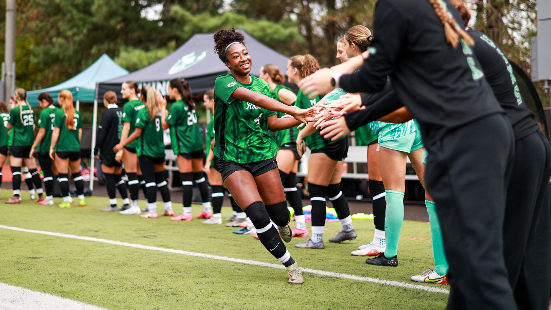 Portland State women's soccer player Kamaria Hughes high-fives her teammates while being announced as a starter