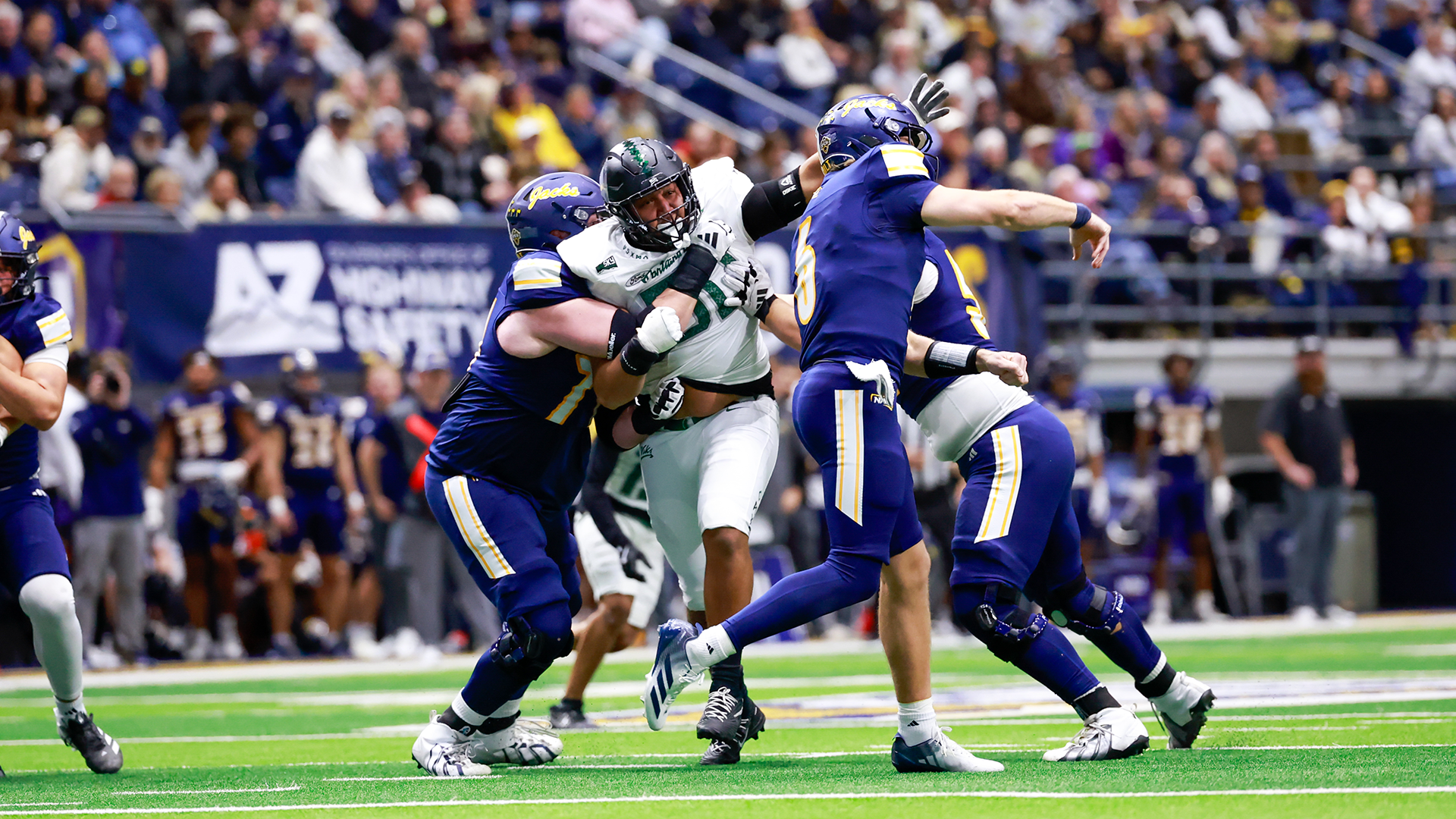 Portland State football player Eddie Vega busts through the line in the Vikings' game against Northern Arizona.