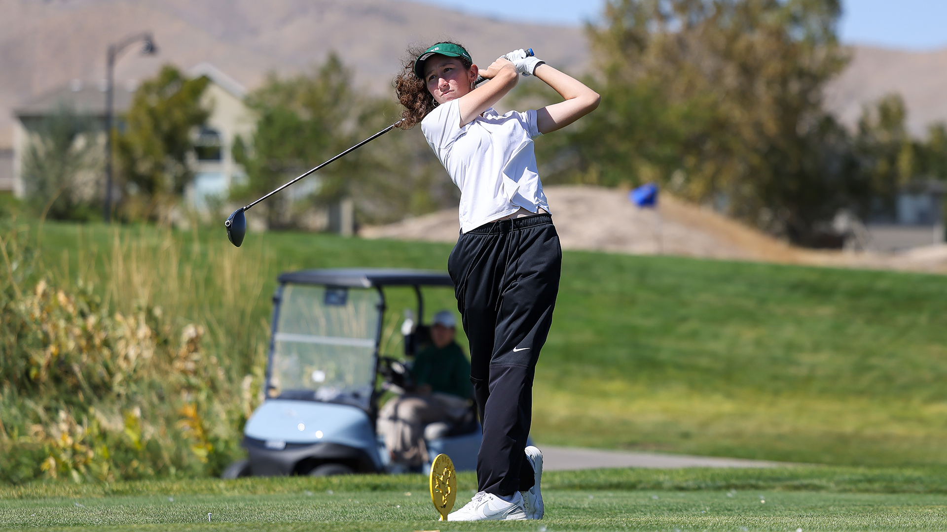 Portland State women's golfer Francesca Tomp drives off a tee box at the Wolverine Invitational.