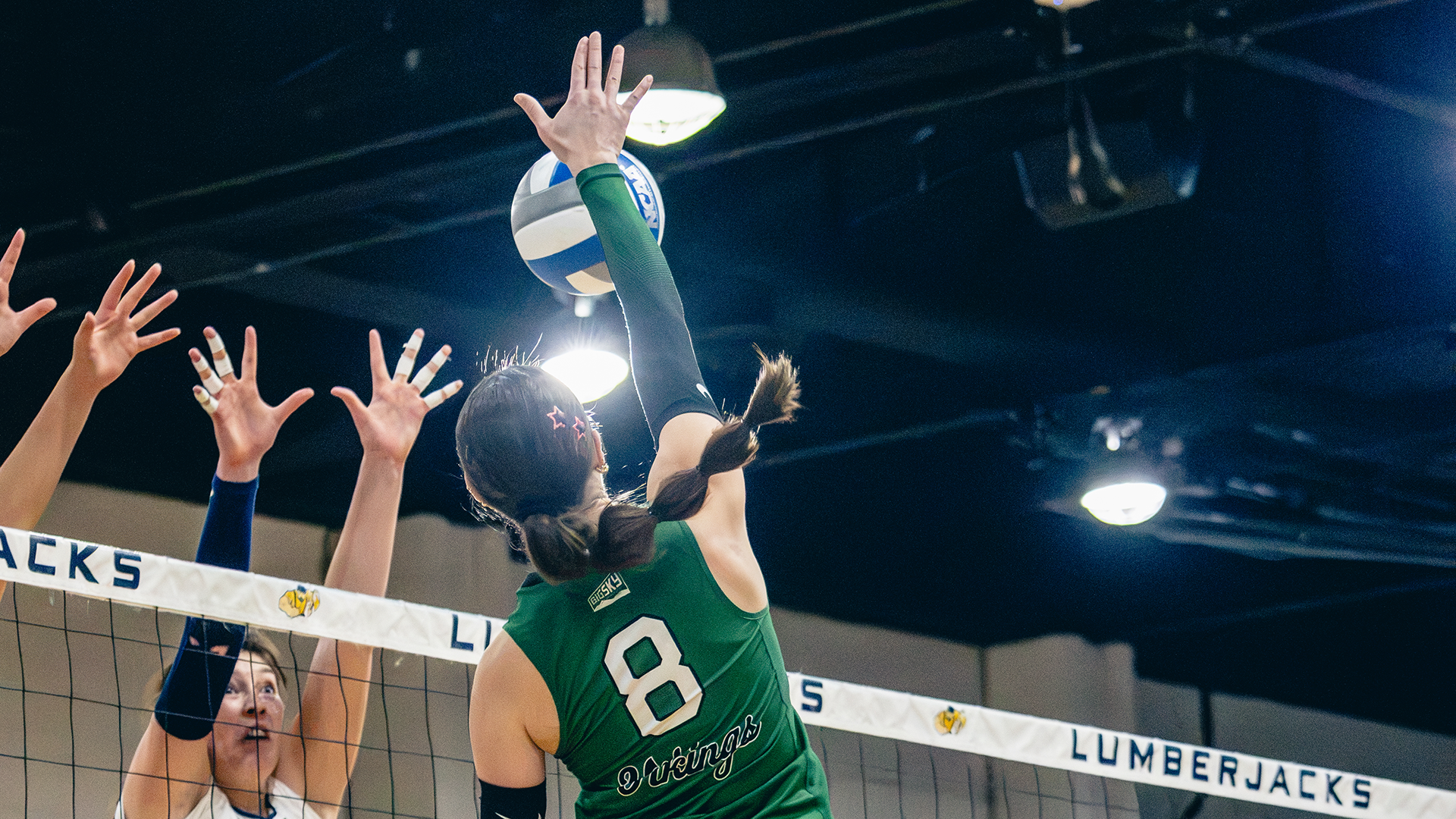 Portland State volleyball player Maryn Hall puts an attack over the net during the Vikings' road match at Northern Arizona
