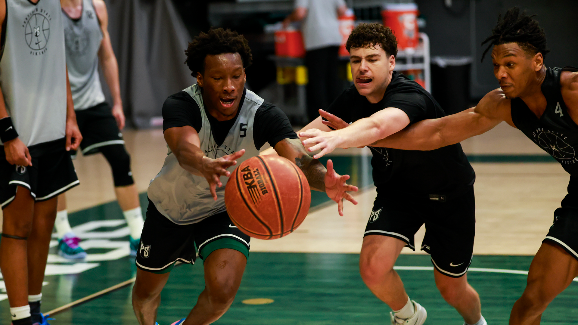 Portland State men's basketball players Trevor Frank and Colt Ness battle for a loose ball during a team practice.