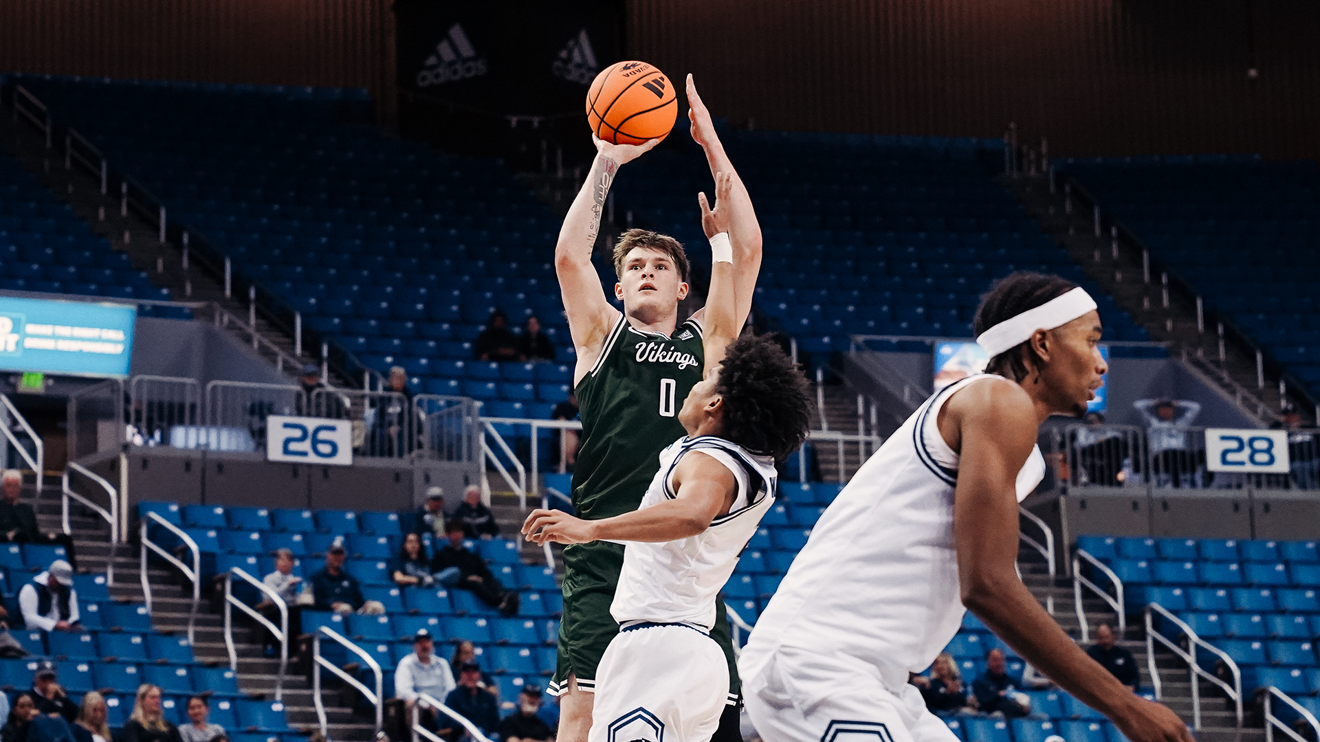 Portland State men's basketball player Yaroslav Nikonov shoots over a defender during the Vikings' exhibition against Nevada.