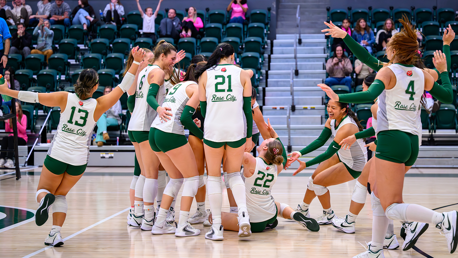 Portland State volleyball players rush the court to celebrate their home win over Northern Colorado.