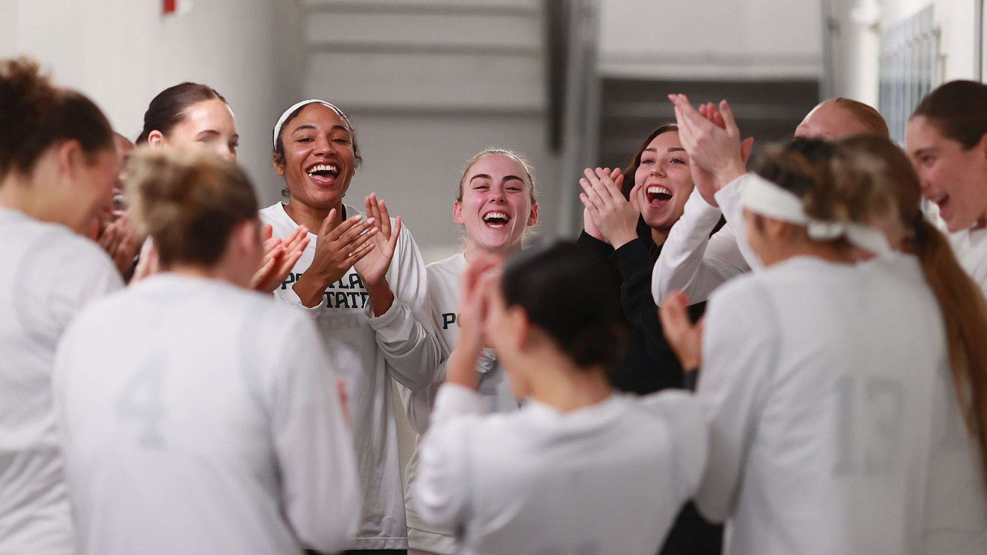 The Portland State women's basketball team huddles together before running out onto the court before a game.
