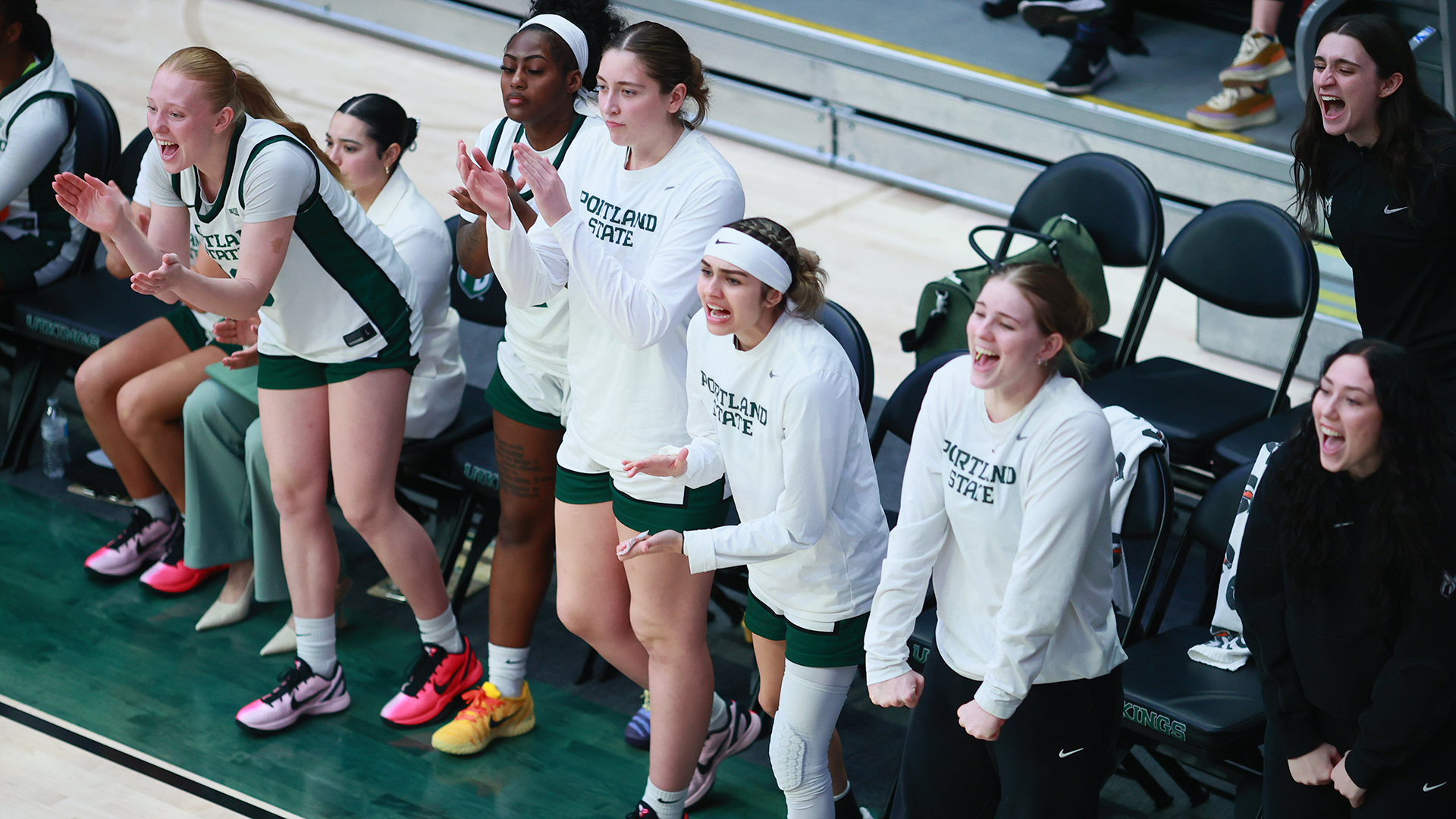 The Portland State women's basketball team's bench celebrates a play during the team's home against Northern Arizona.