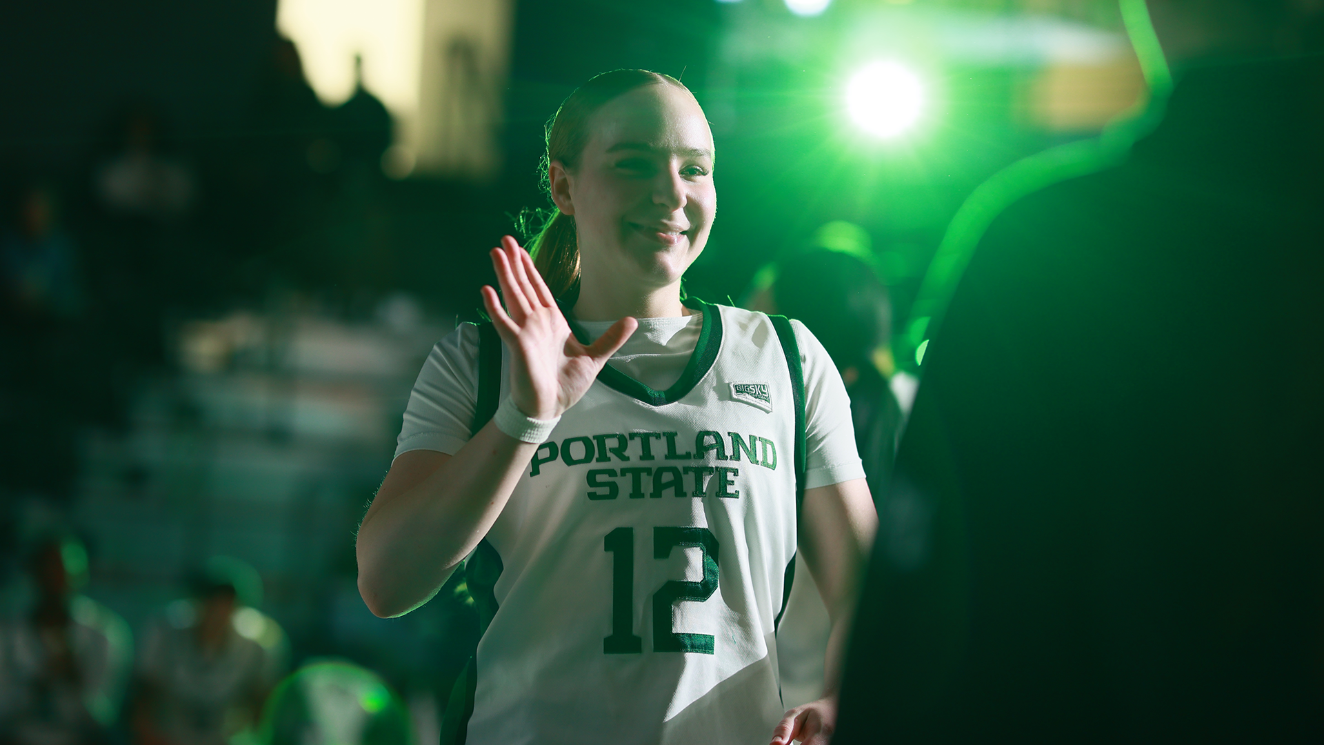Portland State women's basketball player Kyleigh Brown high-fives a teammate while being announced as a starter.