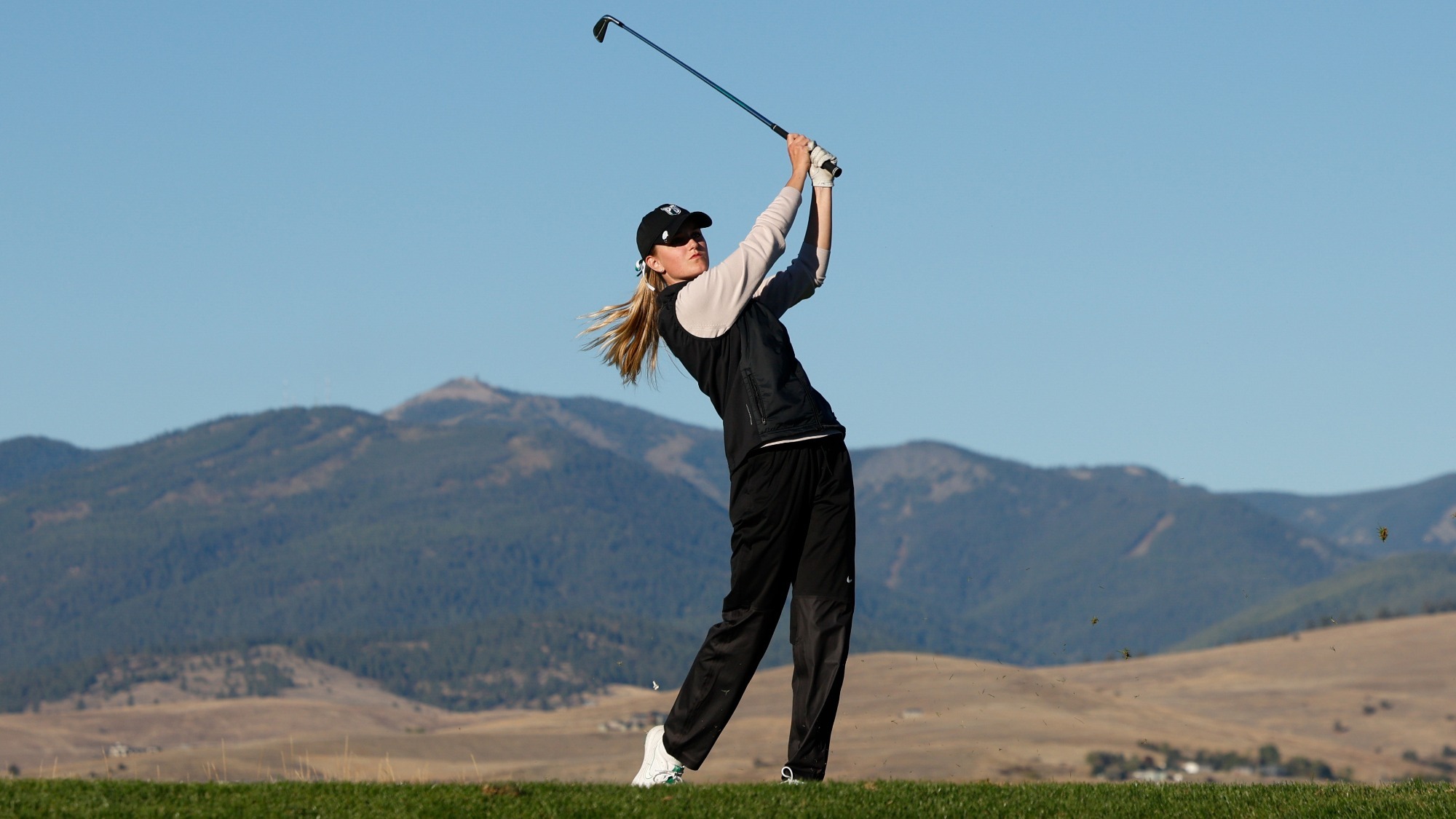 Maddie Dustin hits an iron shot