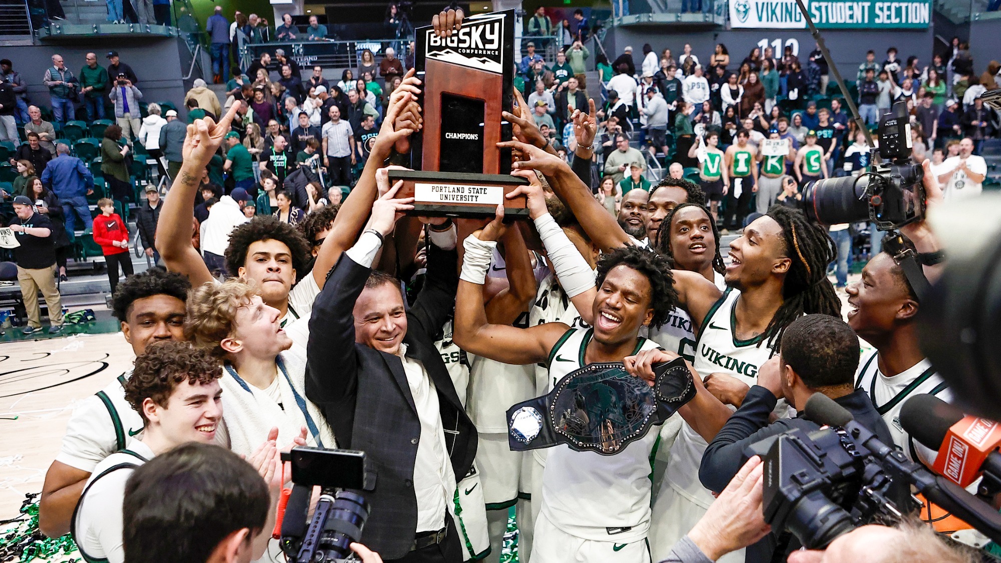 Head Coach Jase Coburn and his team celebrate with the championship trophy