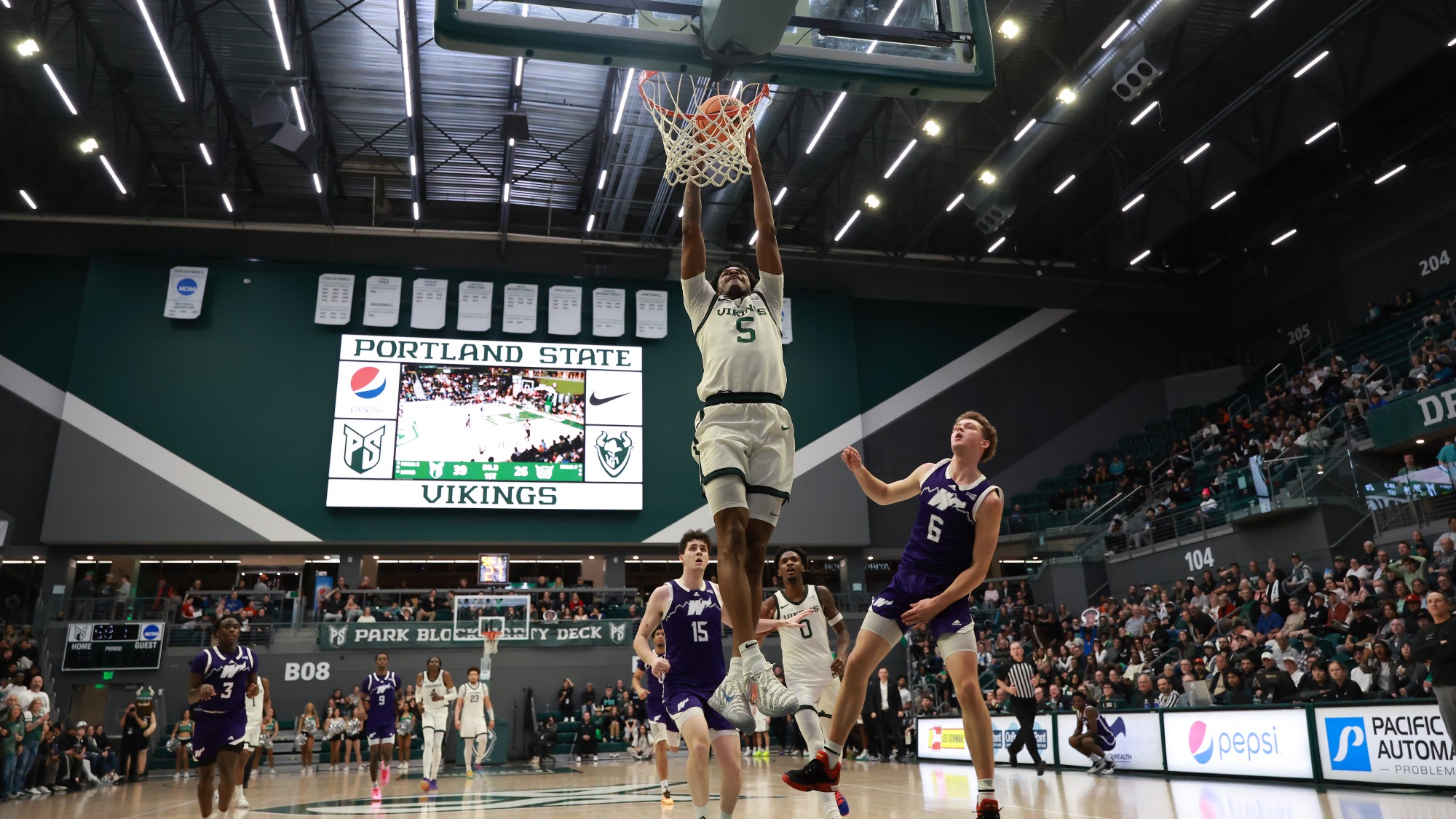 Jaylin Henderson rises for a breakaway dunk against Weber State
