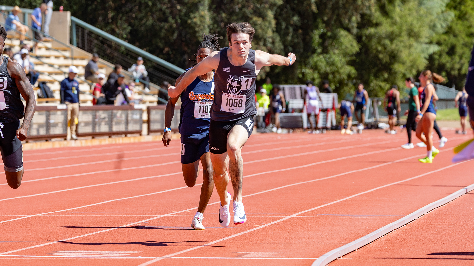 Portland State track & field runner Jack Macdonald leans at the line in the 100 meters at the Stanford Invitational.