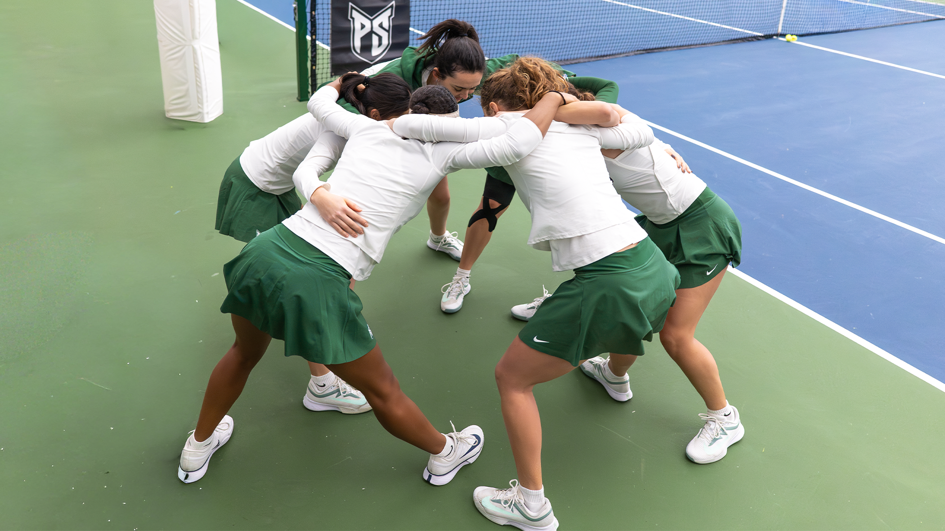 women's tennis team huddles before match