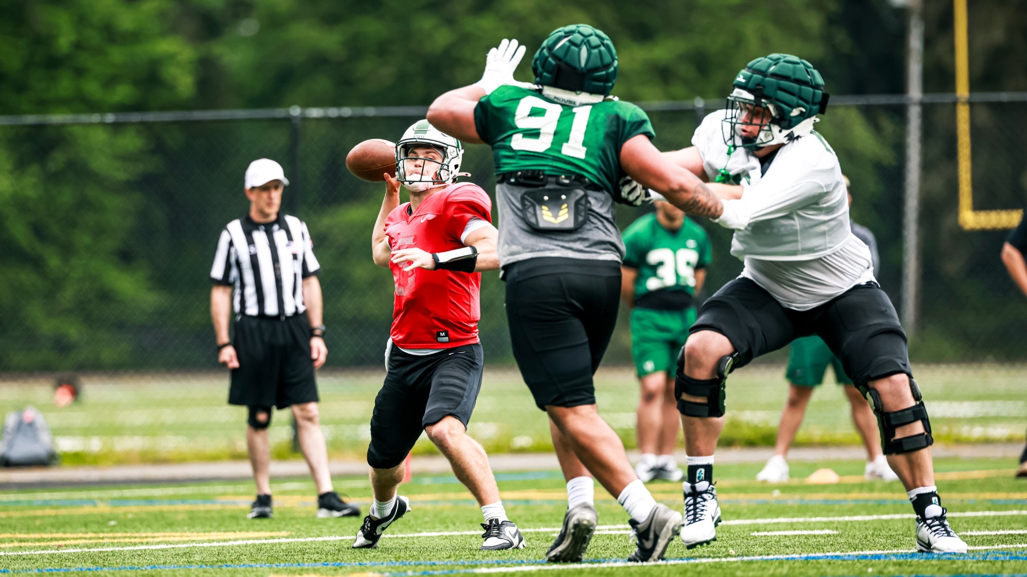 Trey Kennedy-Coleman (91) pressures quarterback Gabe Downing