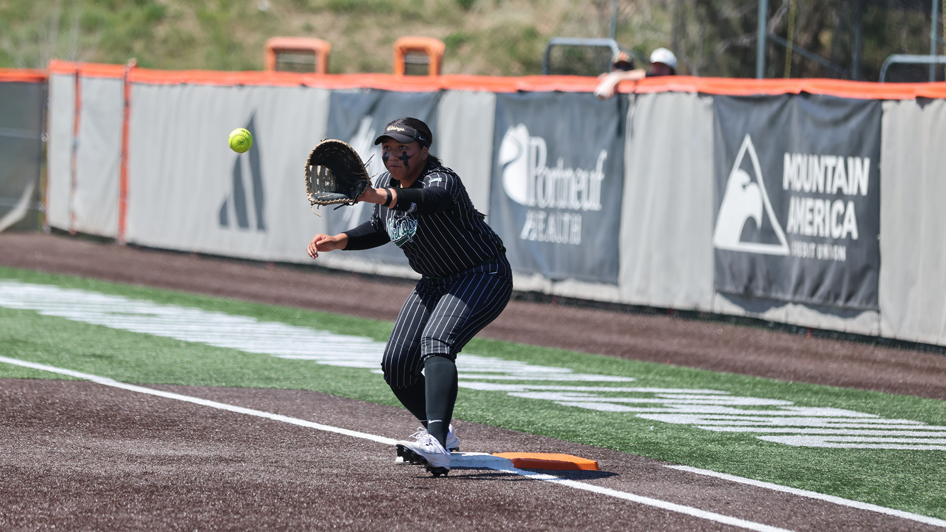Sofia Peato catches a ball at first base