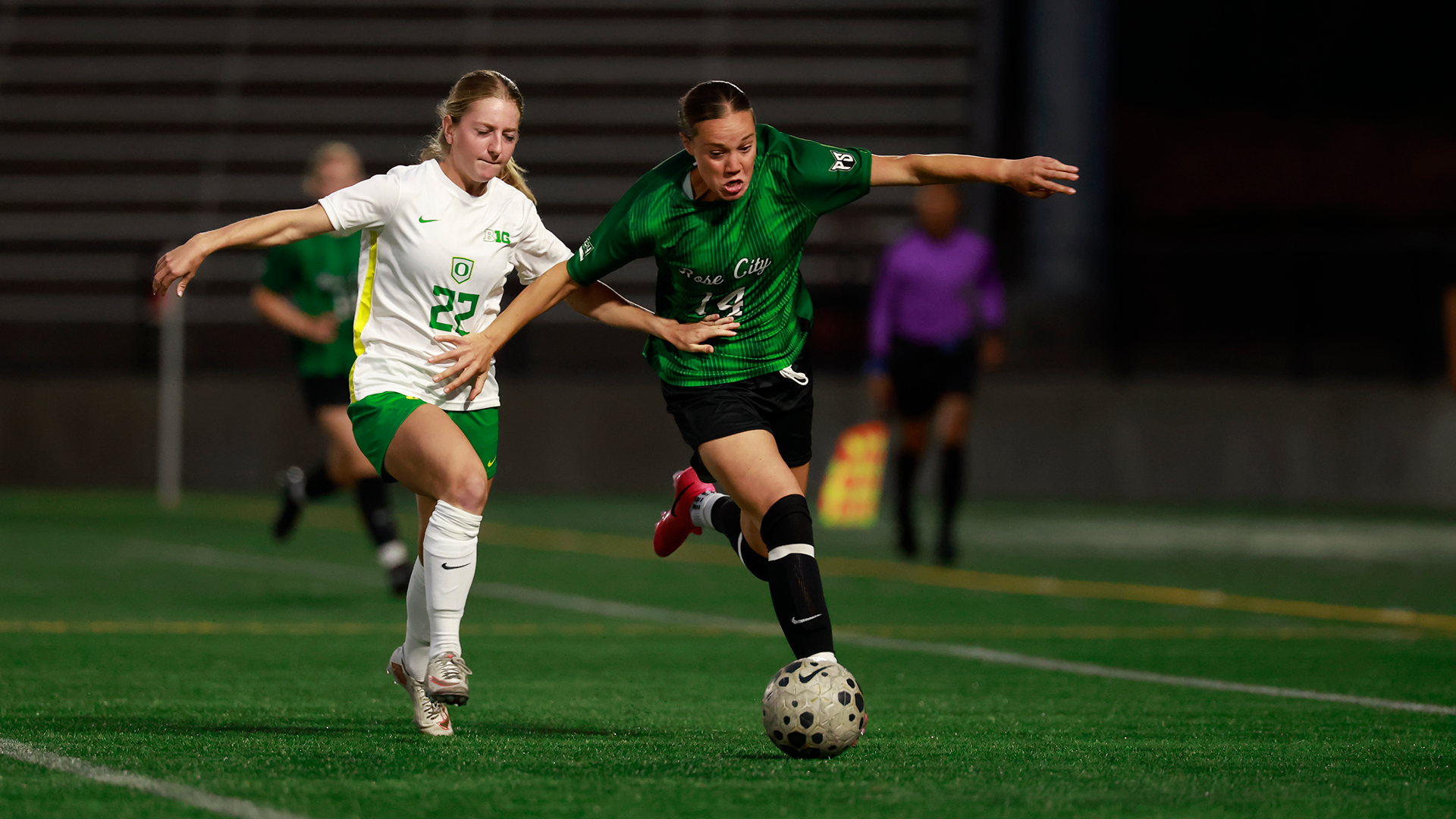 Portland State women's soccer player Elle Frazier fights for a ball against an Oregon player.