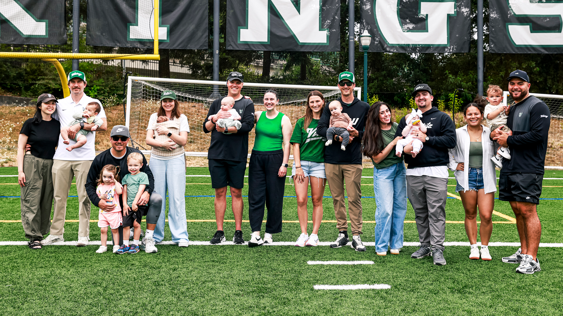 Portland State football coaches and staff members pose with their newborn children.