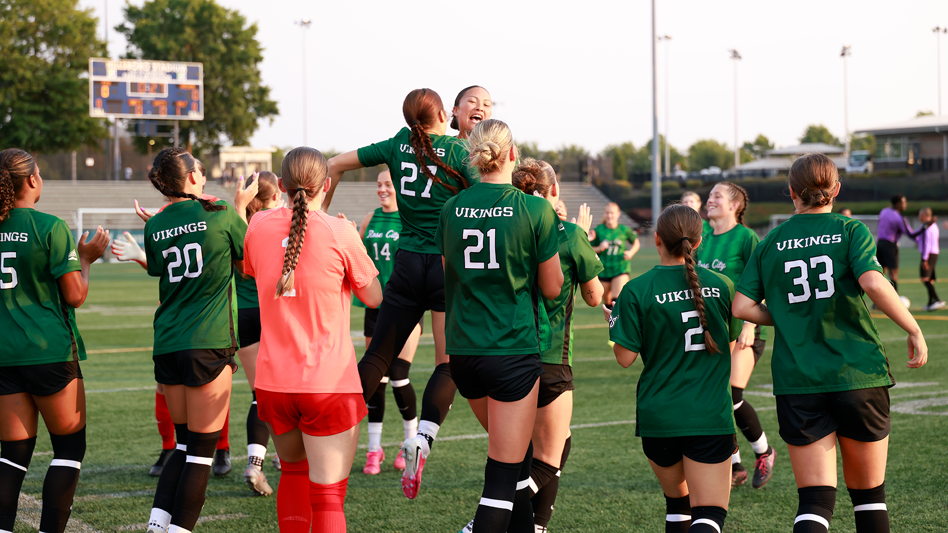Portland State women's soccer players Kainani Jacang and Wynn Farrell chest bump each other before the start of their season opener against Oregon.