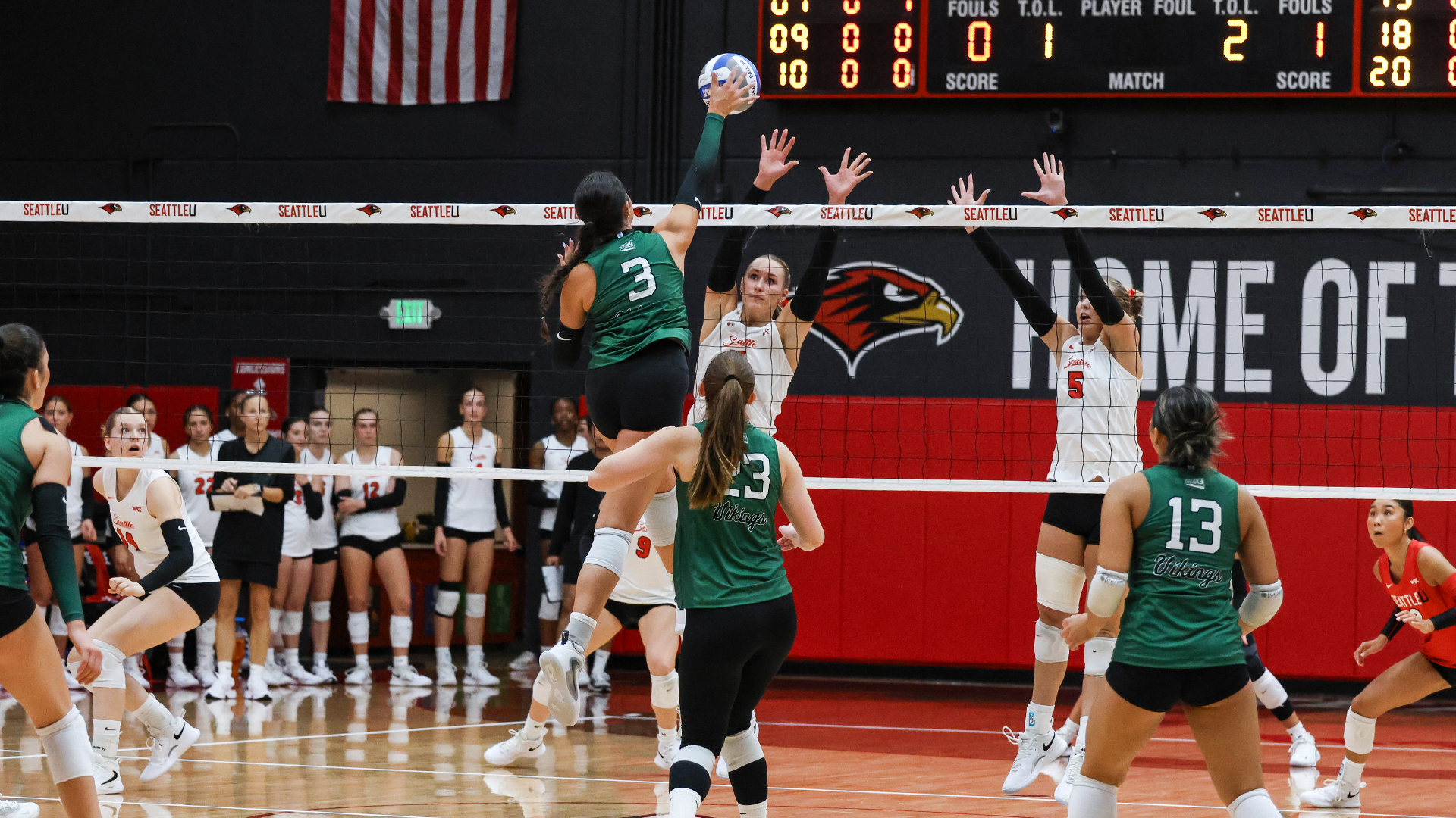 Portland State volleyball player Brenna Coffman hits a ball past a Seattle U defender at the net during the Vikings' exhibition against the Redhawks.