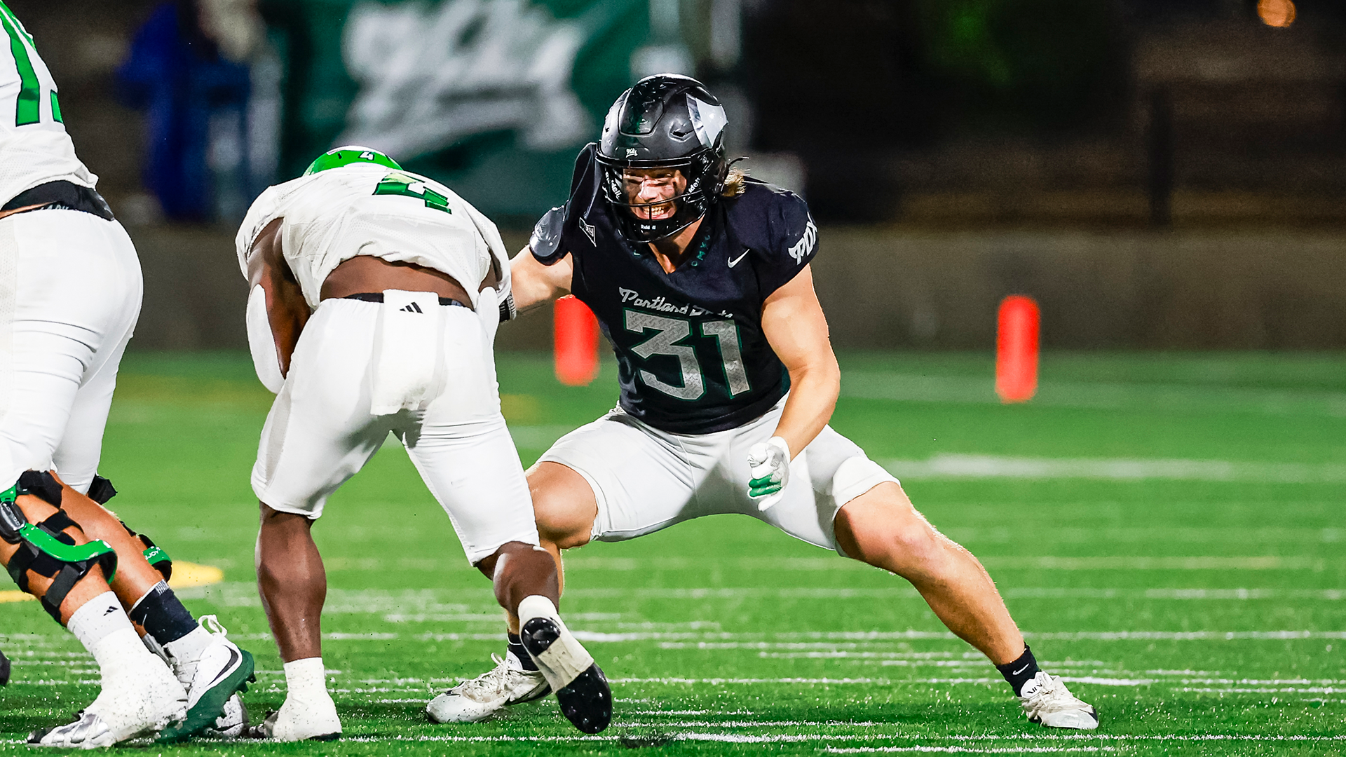 Logan Lisherness, linebacker for the Portland State football team, readies himself to tackle a North Dakota player.