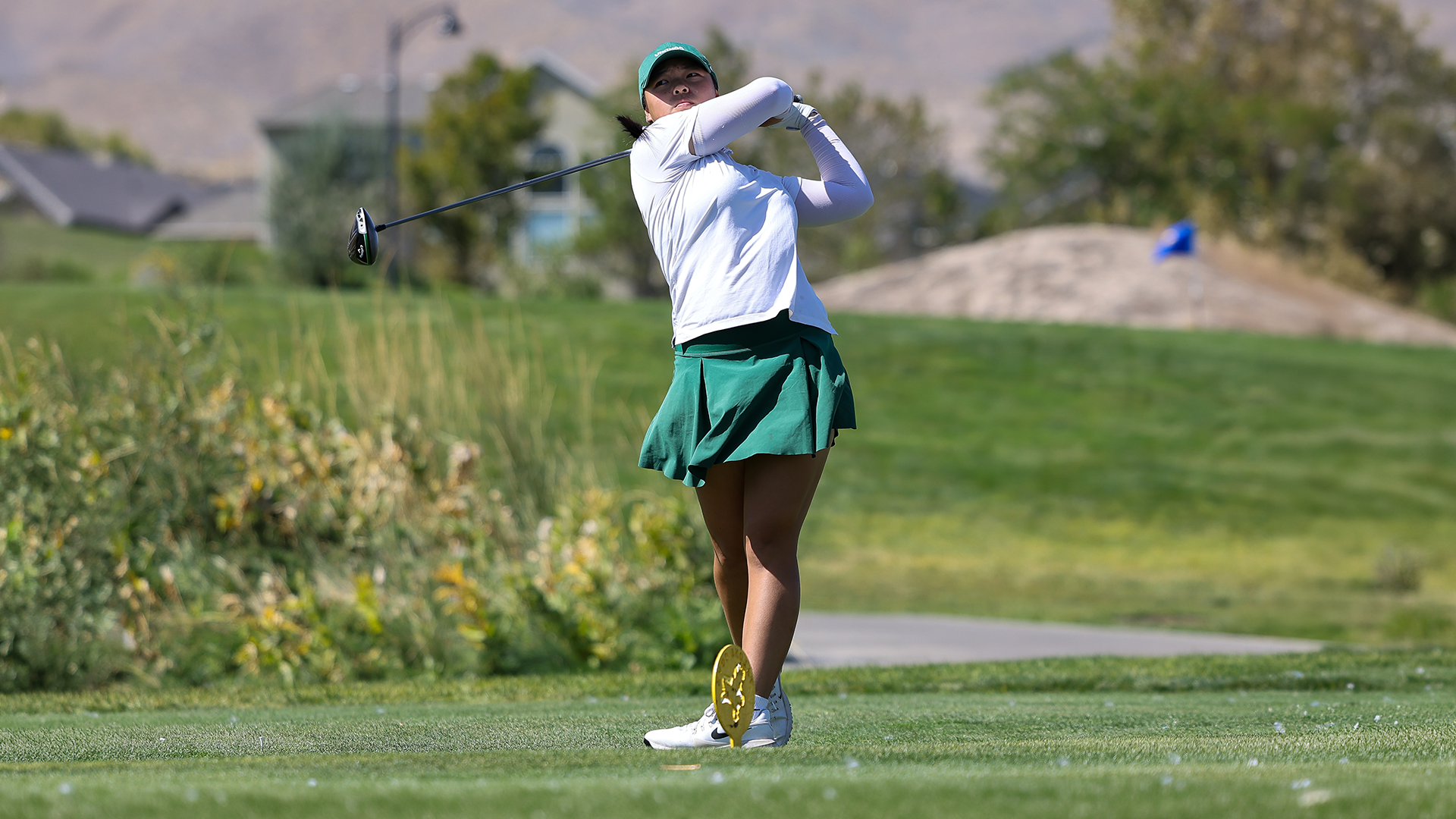Portland State women's golfer Cynthia Valerie Ong follows her shot after driving off a tee box during the Wolverine Invitational.