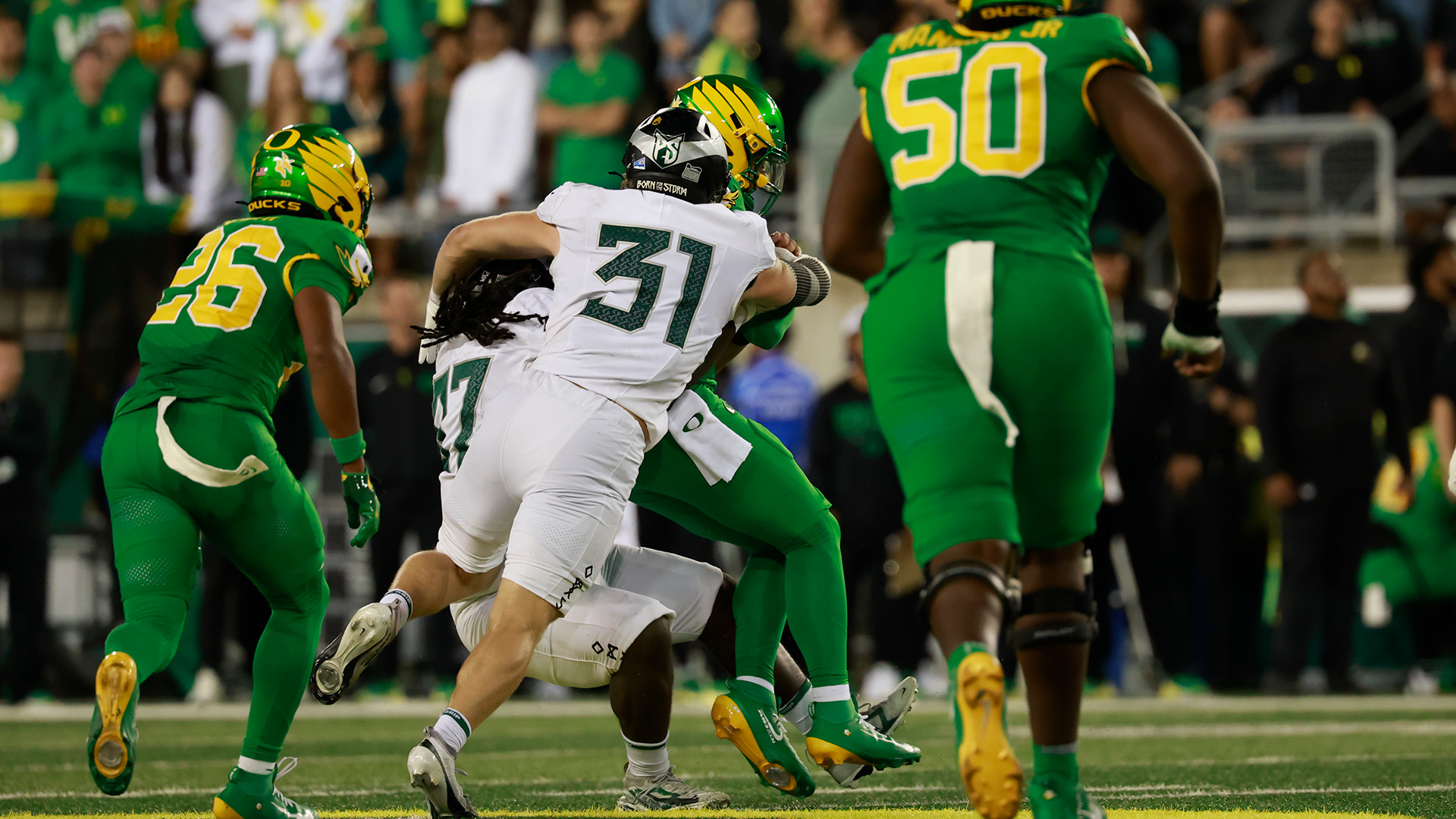Portland State football players Javon Taylor and Logan Lisherness combine for a sack in the third quarter of the Vikings' game at Oregon.