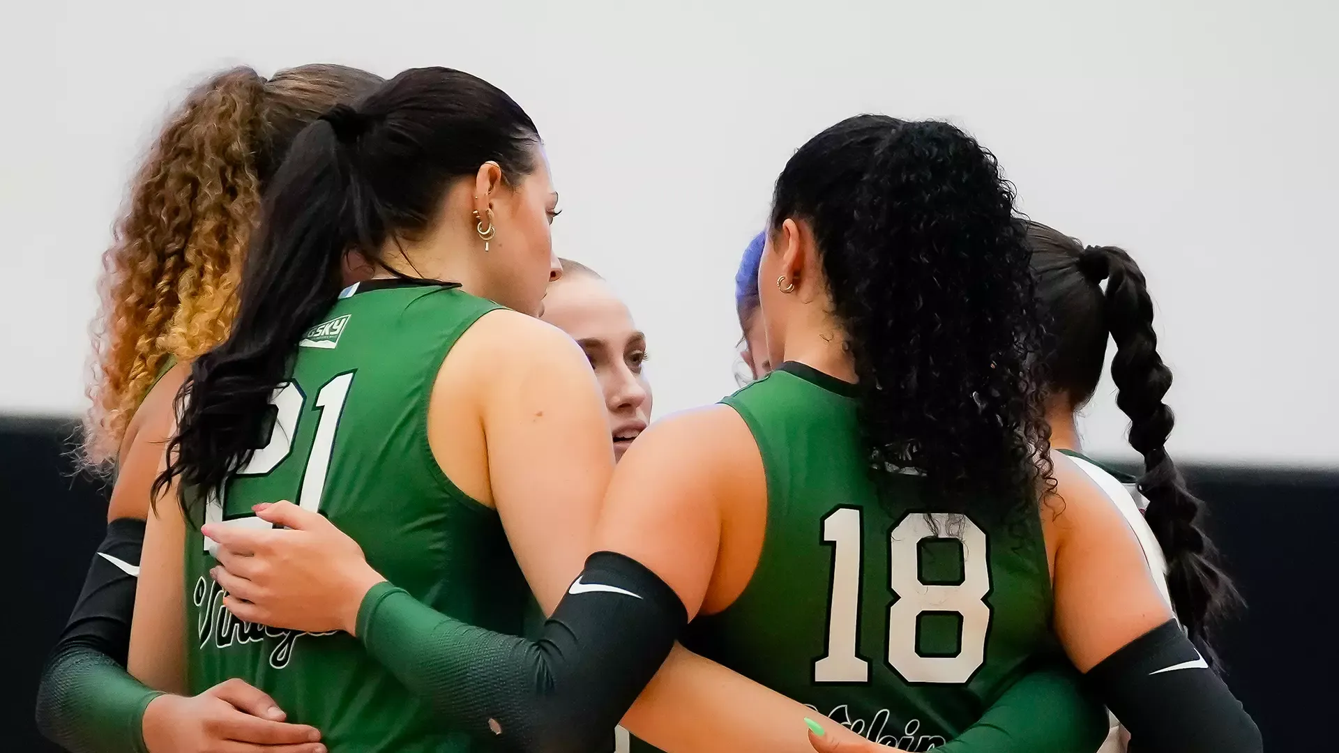 The Portland State volleyball team huddles together during their match at DePaul.