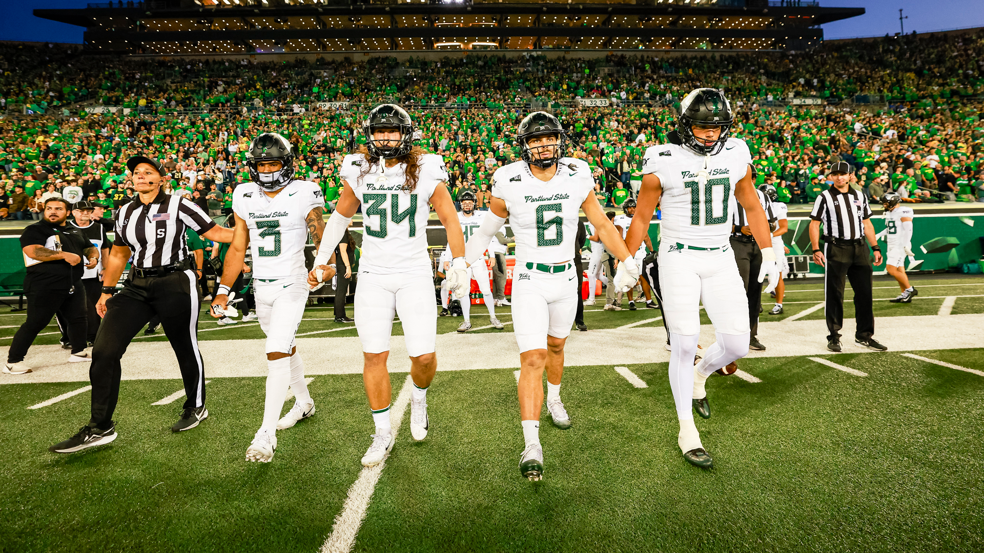 The captains of the Portland State football team walk out to midfield for their coin toss against Oregon.