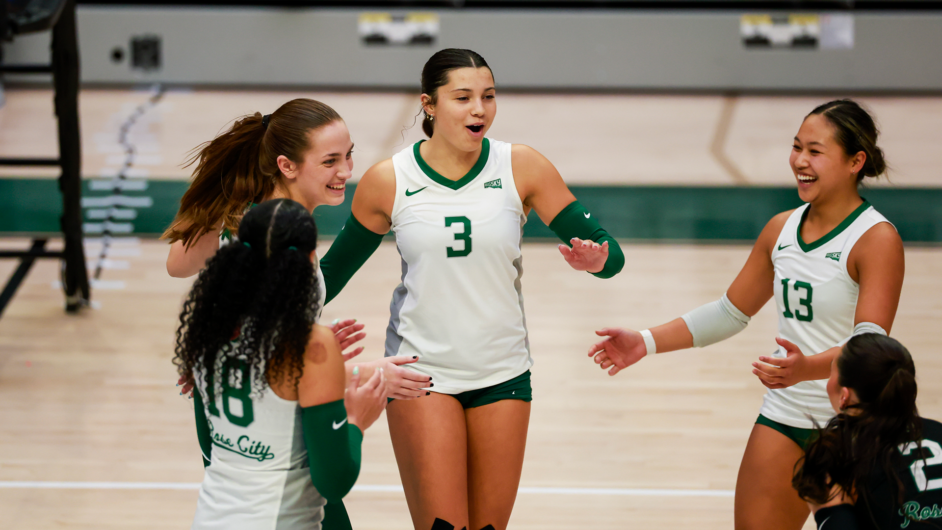 Portland State volleyball players celebrate a point during their home match against Nevada.