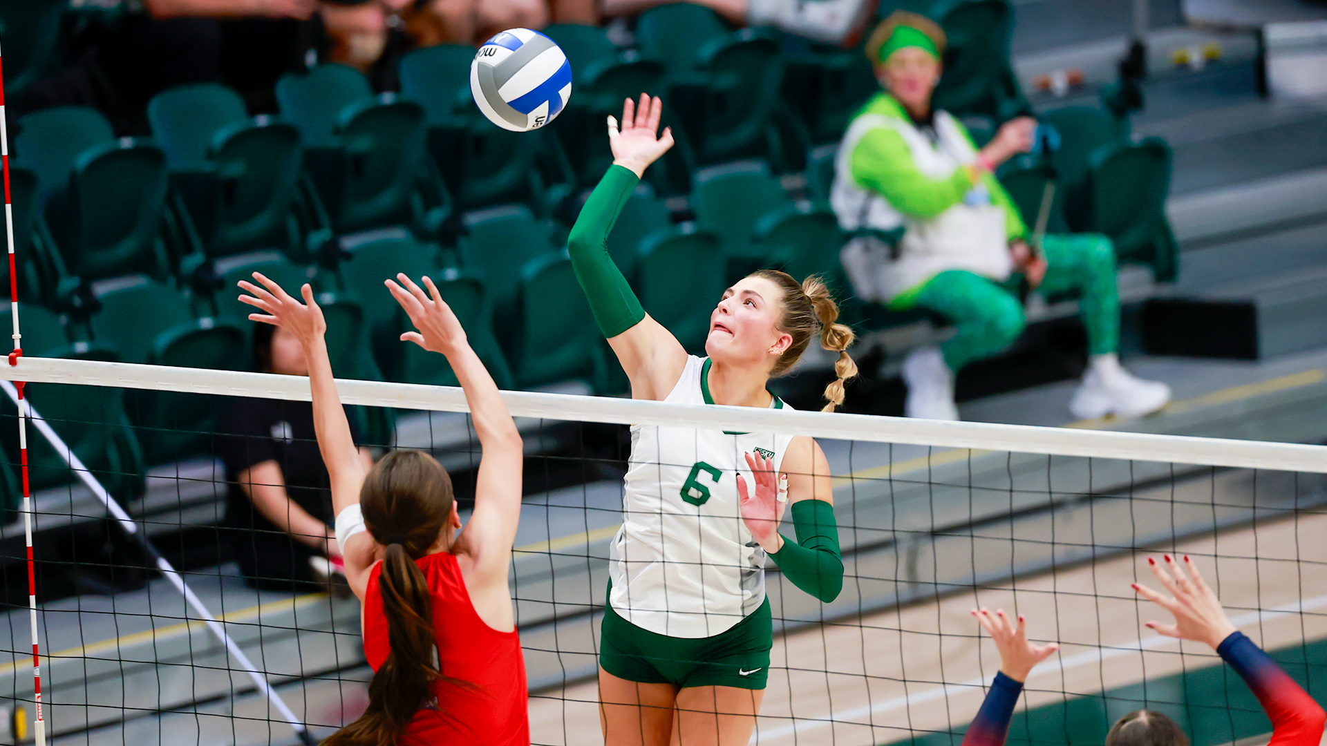 Portland State volleyball player Jordyn Romano hits a ball over the net during the Vikings' home match against Utah Tech.