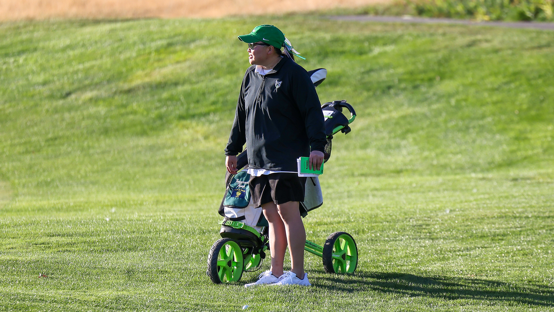 Portland State head women's golf coach Kaylee Shimizu observes one of her players at the Wolverine Invitational