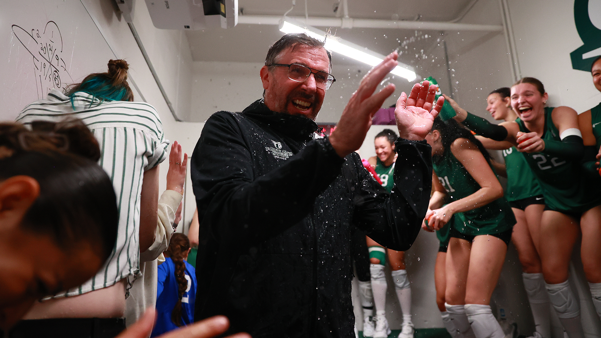 The Portland State volleyball team celebrates its win over Southern Utah in the locker room after the match.
