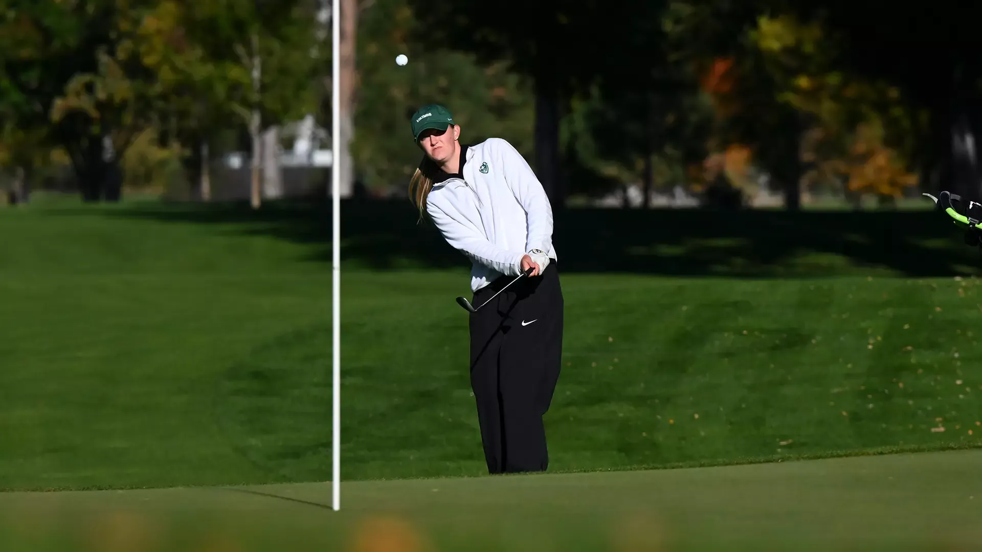 Portland State women's golfer Maddie Dustin chips a ball onto the green while playing a round at the Sun Mountain Intercollegiate.
