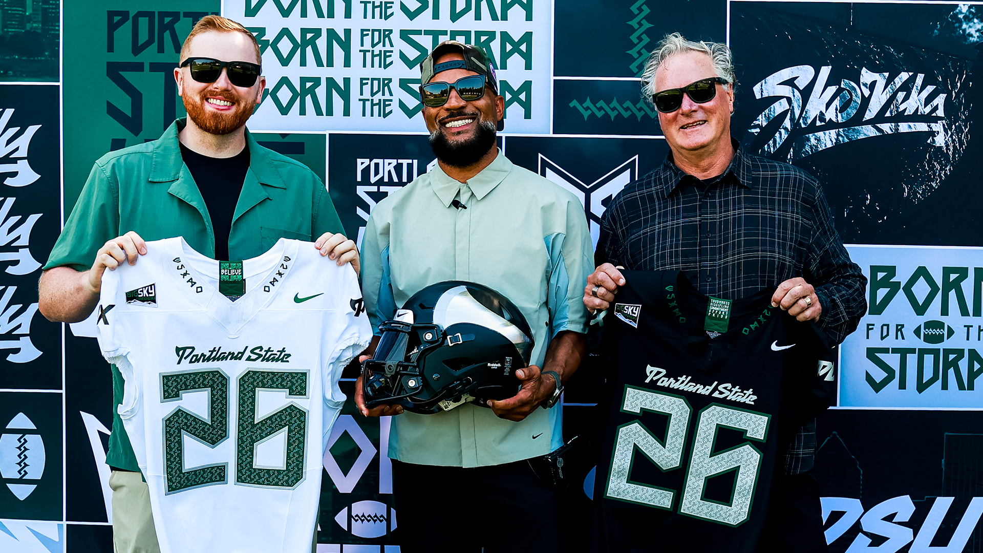 Portland State football general manager Rashad Floyd poses in between Quinn and Todd Van Horne who designed the Vikings' 2026 football jerseys.