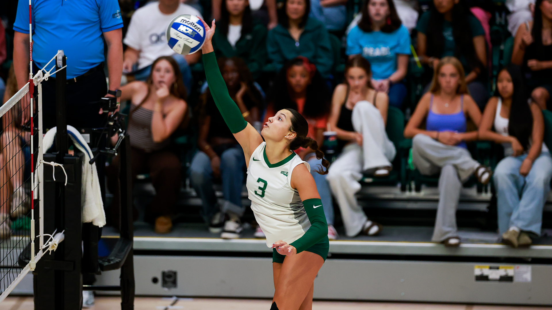 Portland State volleyball player Brenna Coffman hits a ball over the net during a match.