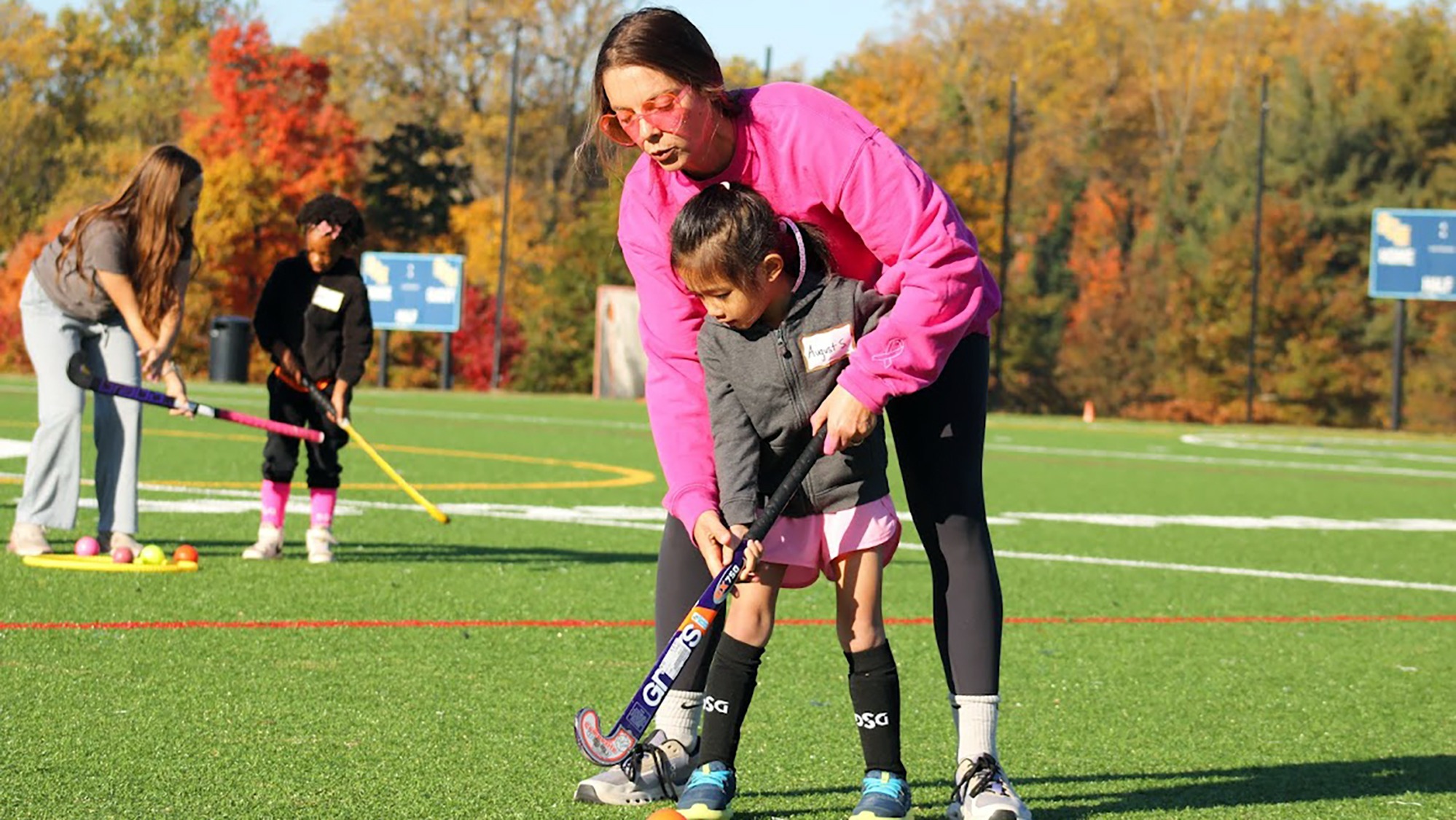 Gretta Ehret teaching youth field hockey