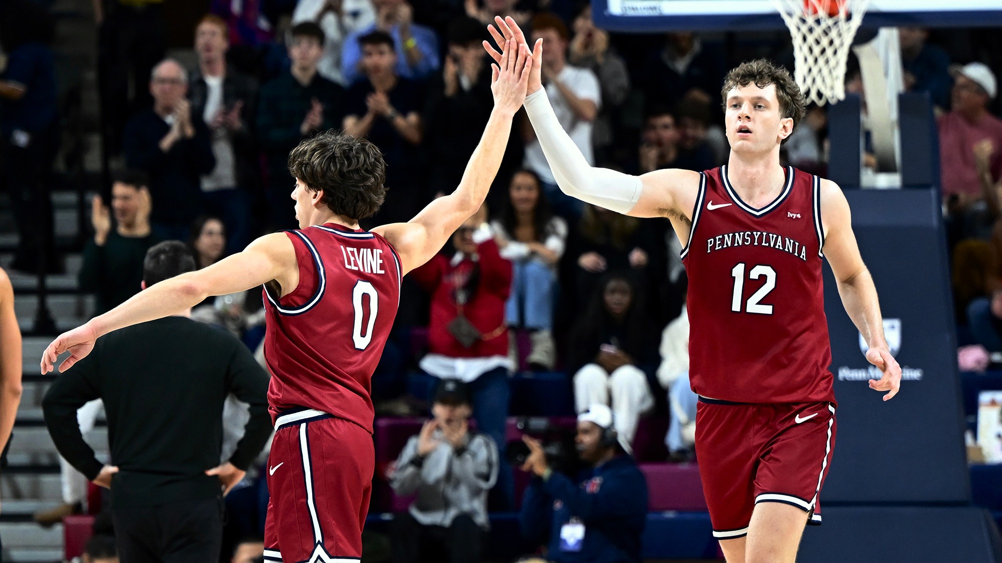 AJ Levine and TJ Power high five during Harvard game 2-28-2026