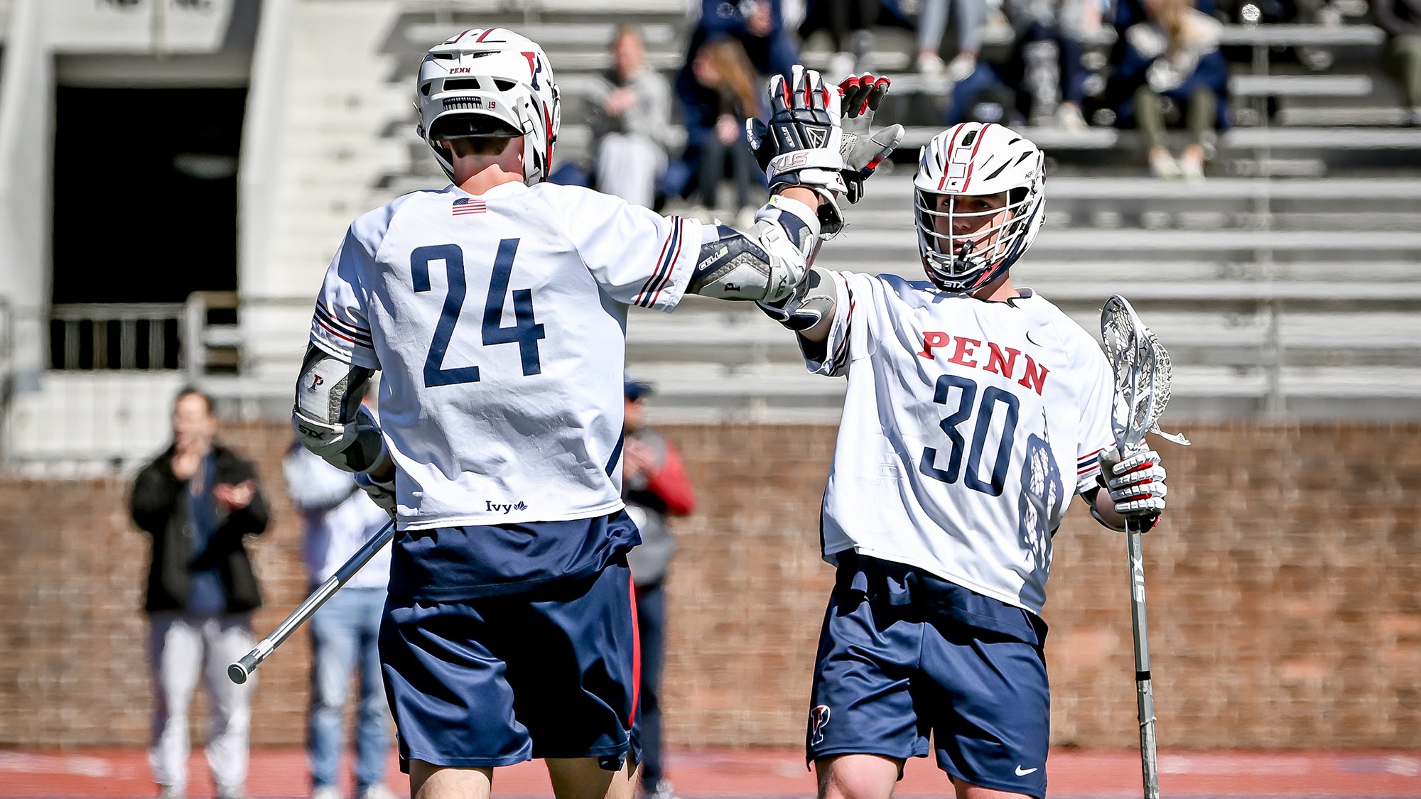 Jackson Maher (24) Nate Lucchesi (30) high five vs. Harvard 3-14-2026