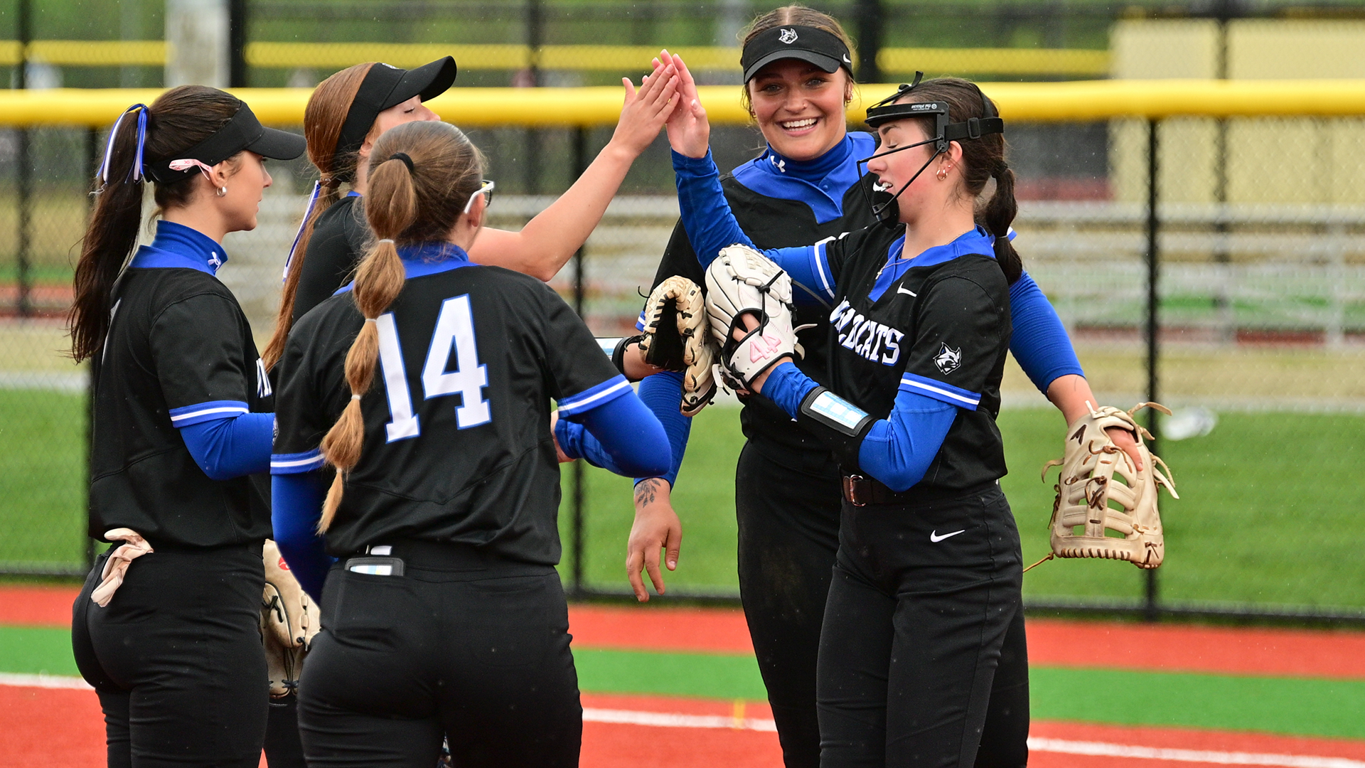 Penn College softball players standing in the pitching circle