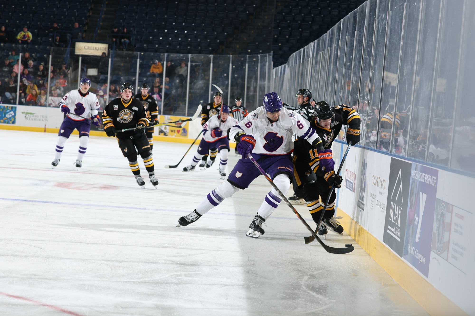 JT VENEY TRIES TO WEDGE A GREEN BAY GAMBLER OFF THE PUCK