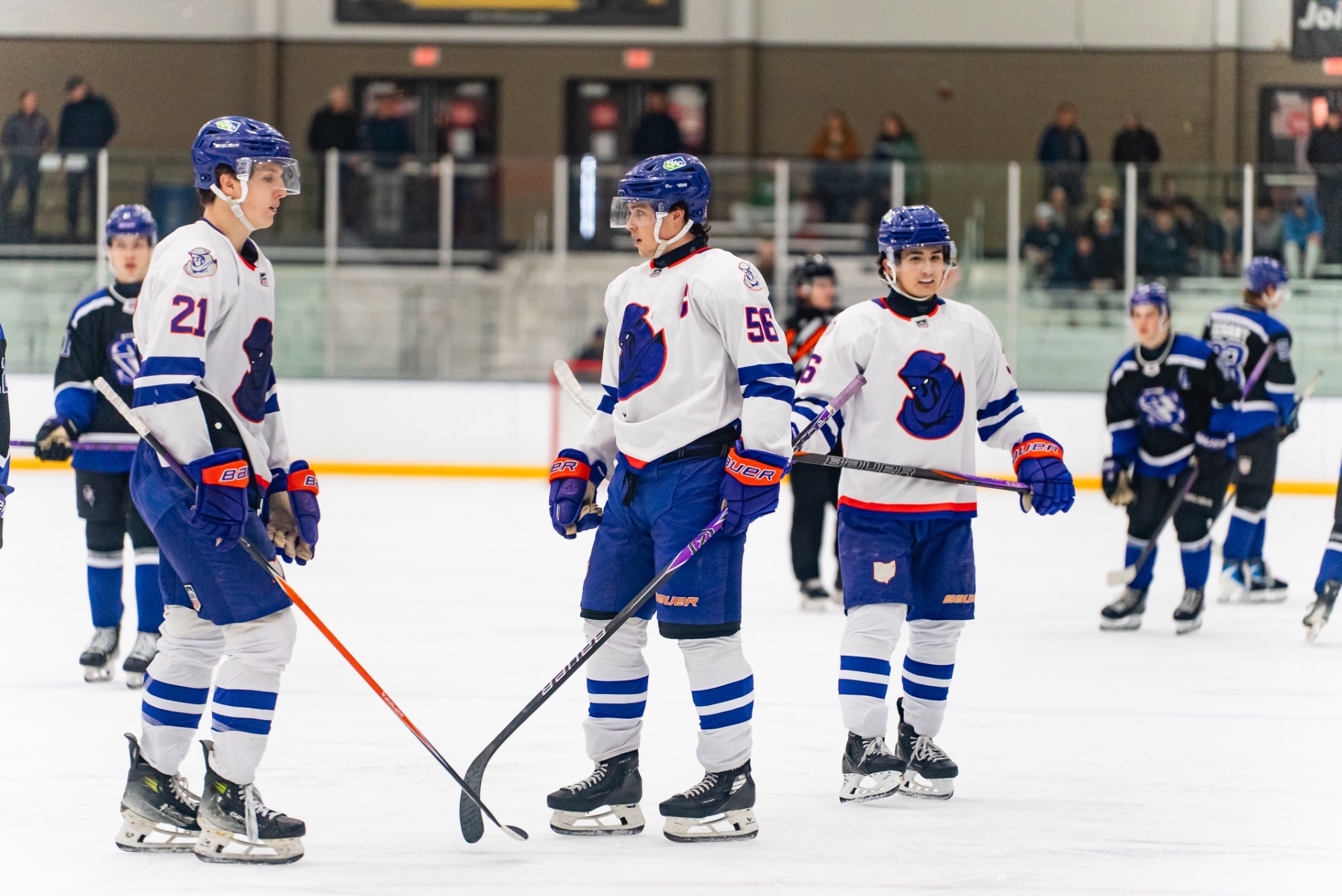 RYAN RUCINSKI (56) DISCUSSES A FACEOFF PLAY WITH COOPER SIMPSON (21)