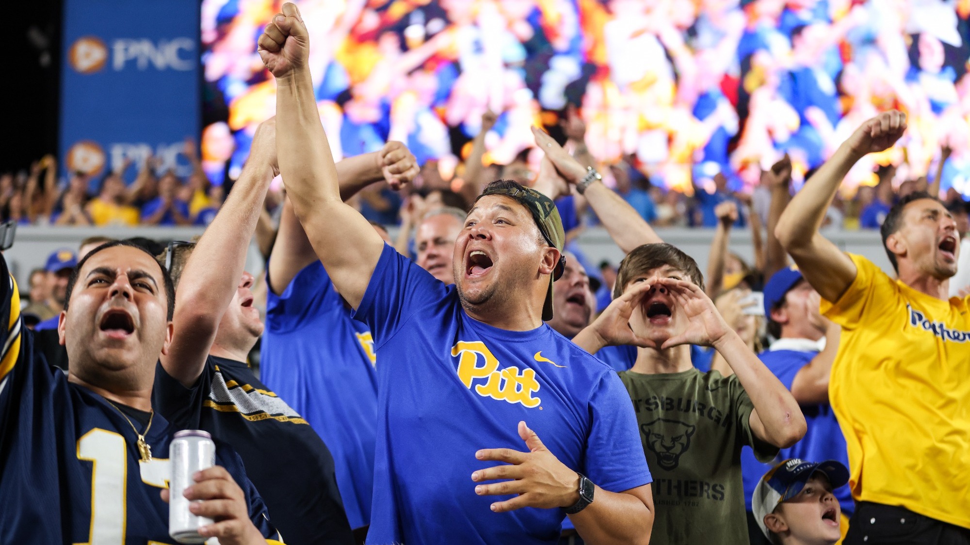 A Pitt fan cheers in the stands at Acrisure Stadium