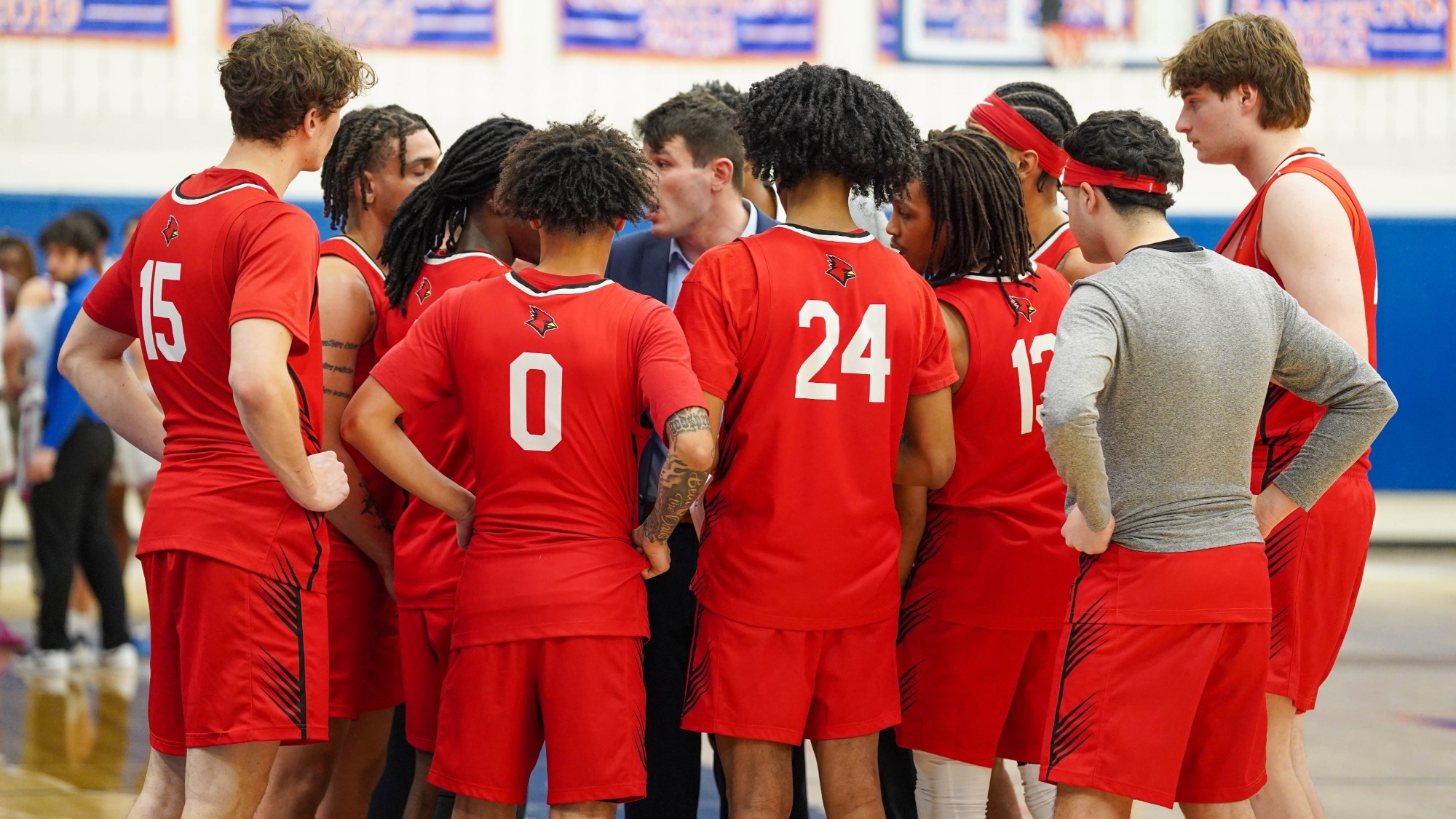 Men's basketball team huddled up during a timeout