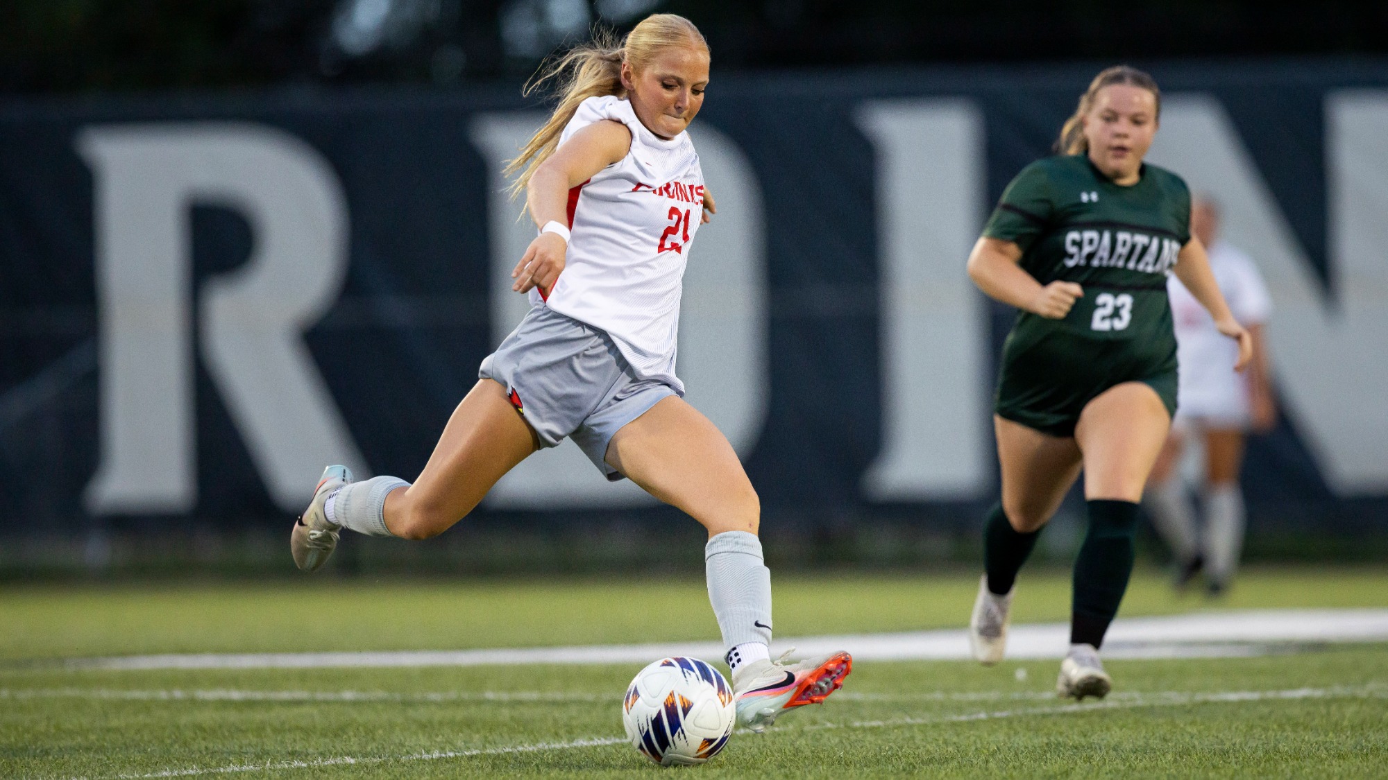 Mariah Nowicki kicking a soccer ball